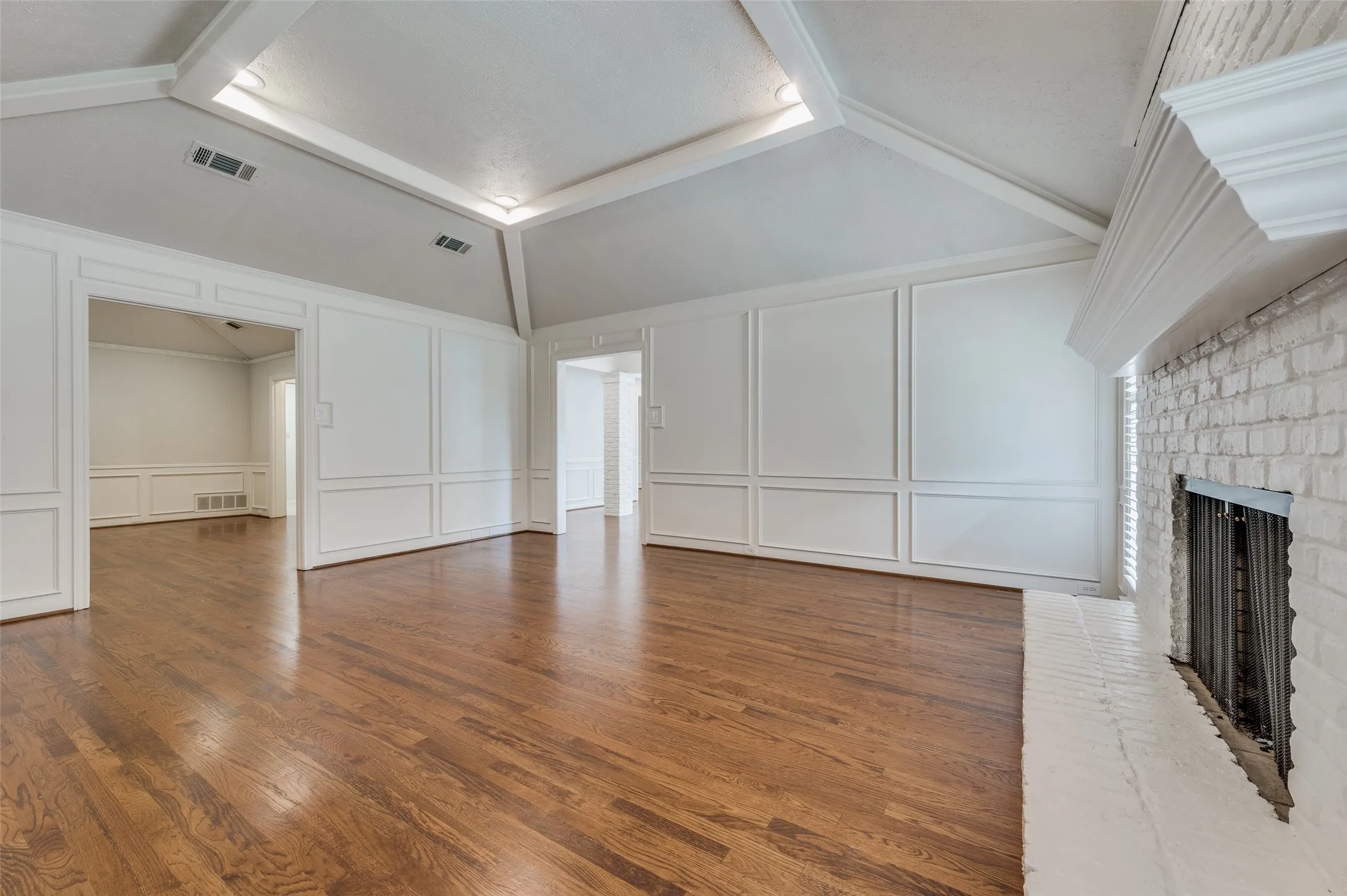 Living room, with den at left rear