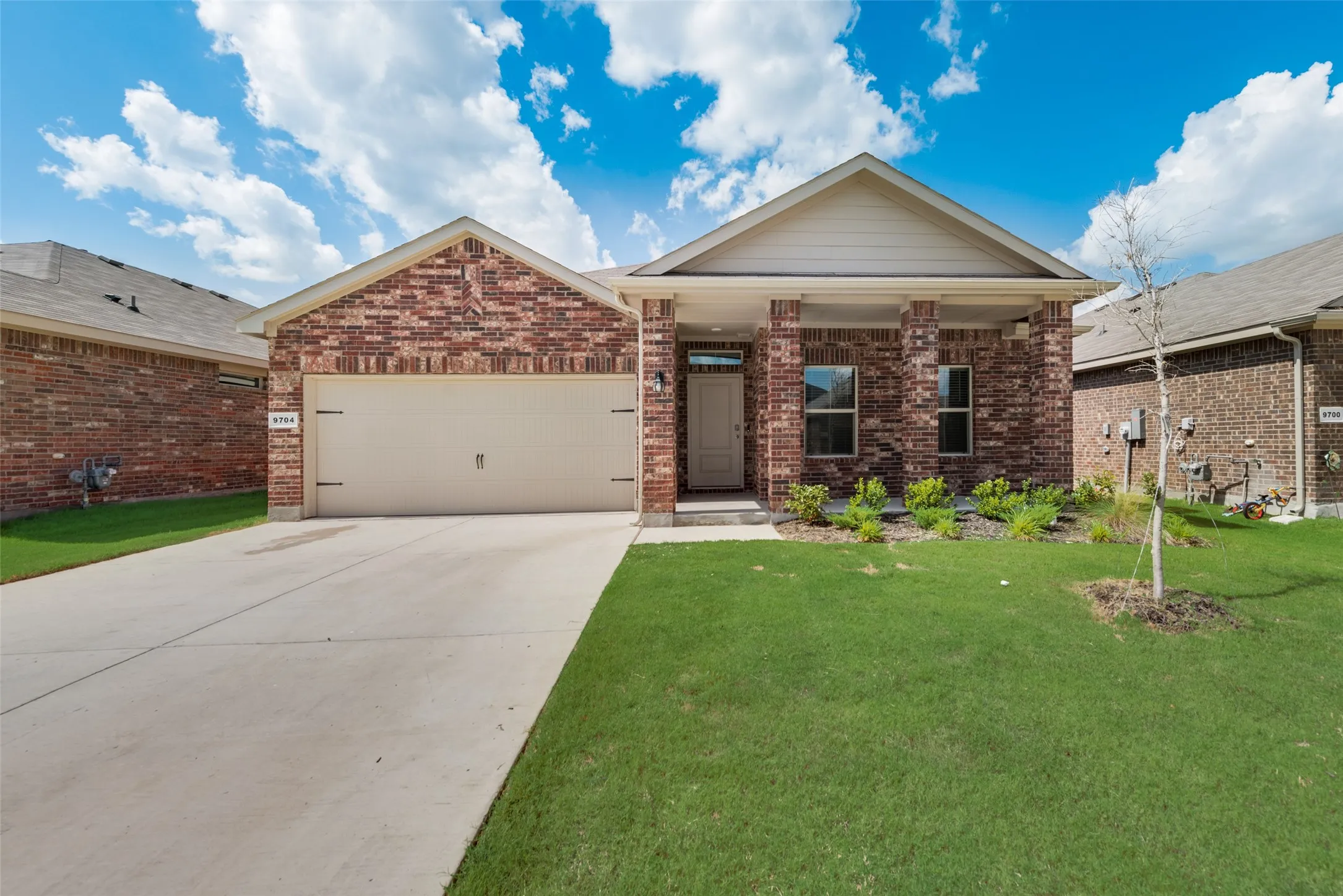 Brick-clad exterior with a covered front porch entry