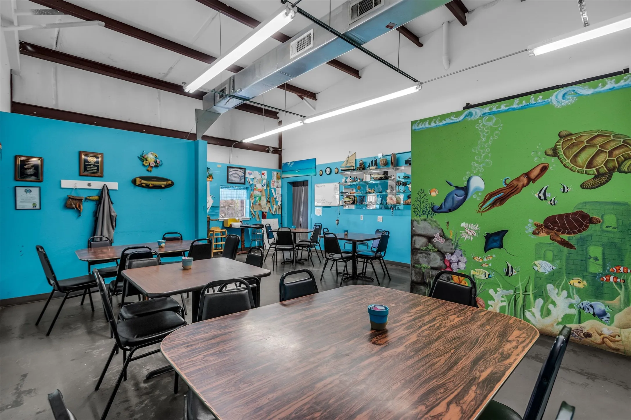 Spacious interior with exposed ceiling beams and ductwork