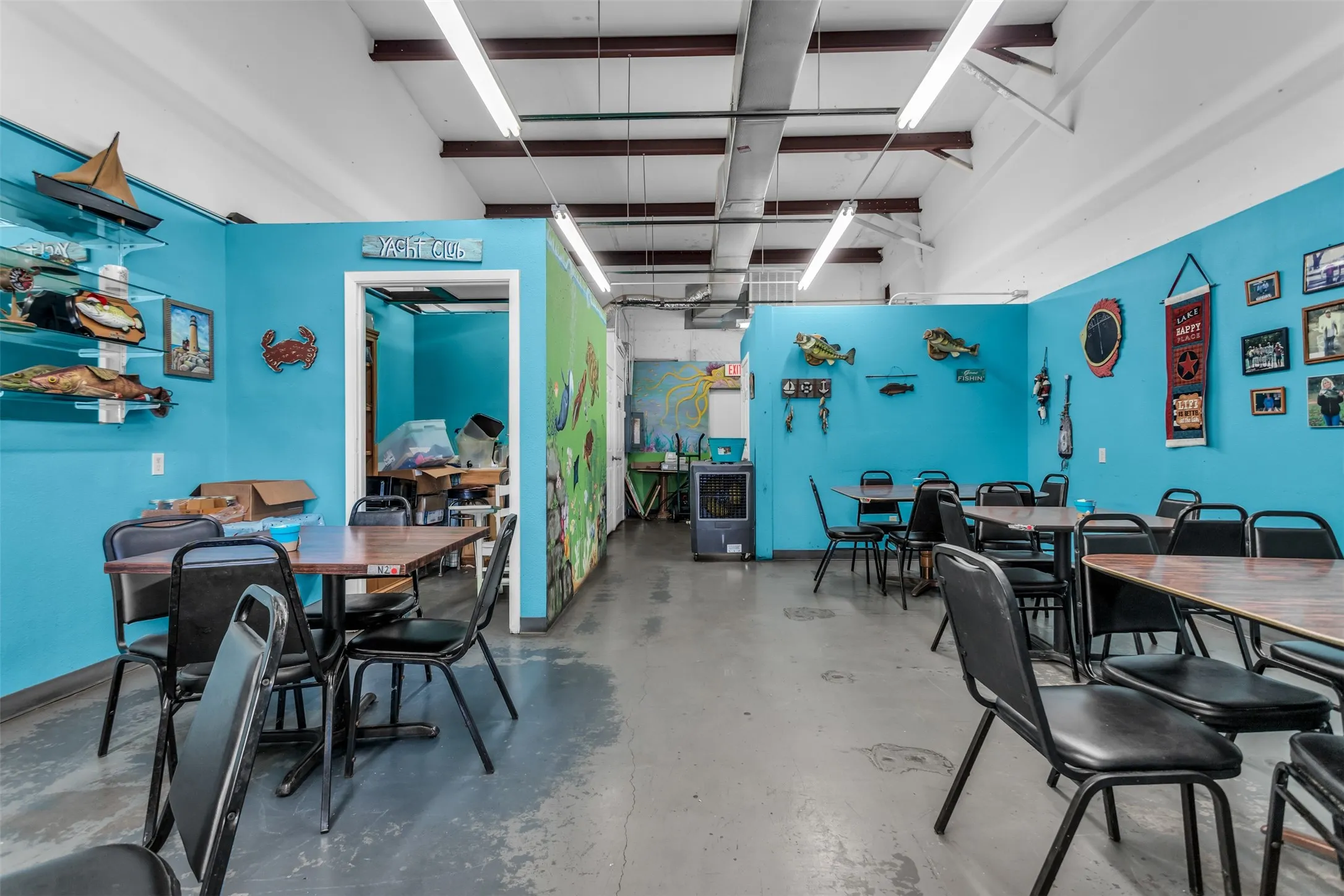 Spacious interior with concrete flooring and bright blue walls