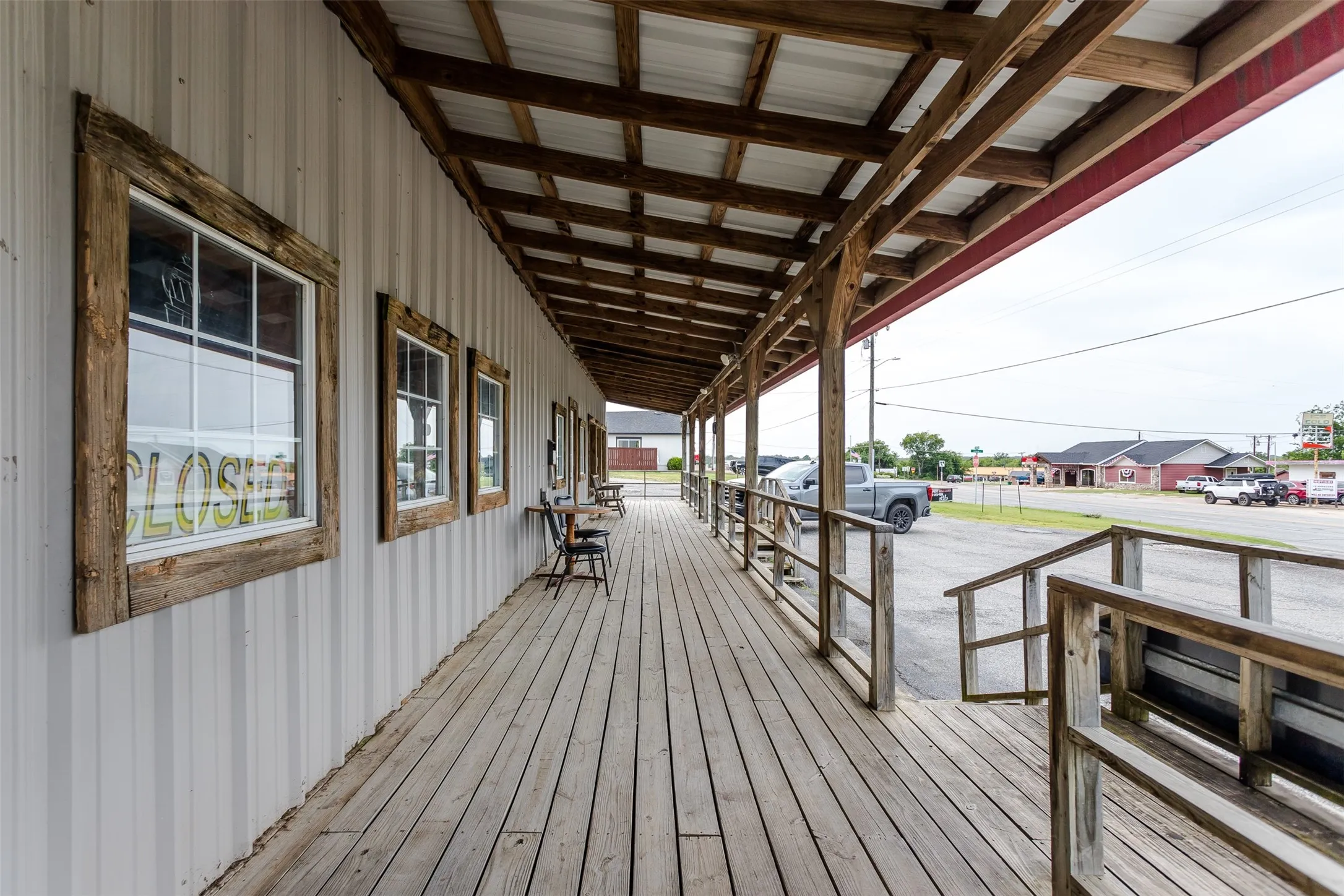 Expansive wood-finish porch with a covered overhead structure