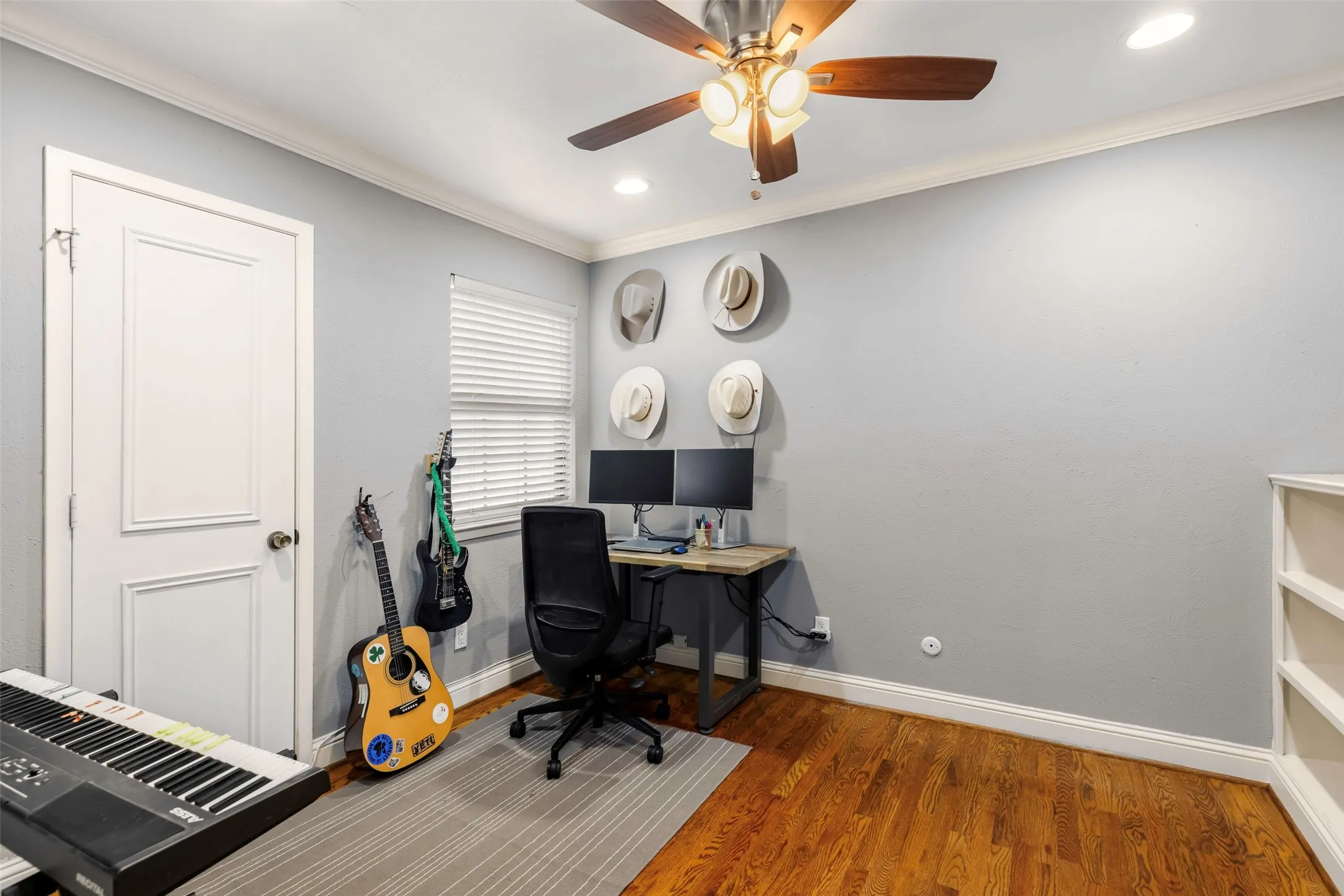 Room featuring wood-finish flooring, a ceiling fan with integrated lighting, recessed lighting, and a window with blinds