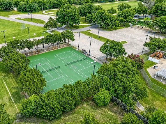 Two tennis courts with a hard-court surface and perimeter fencing