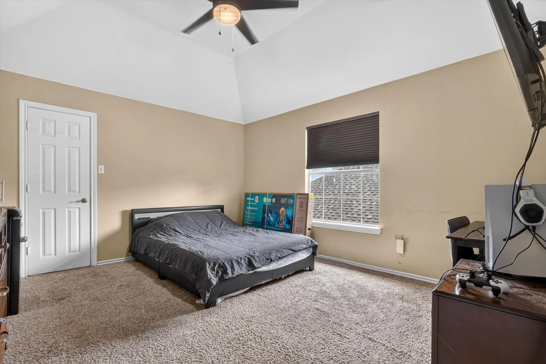 Room featuring vaulted ceilings and a ceiling fan