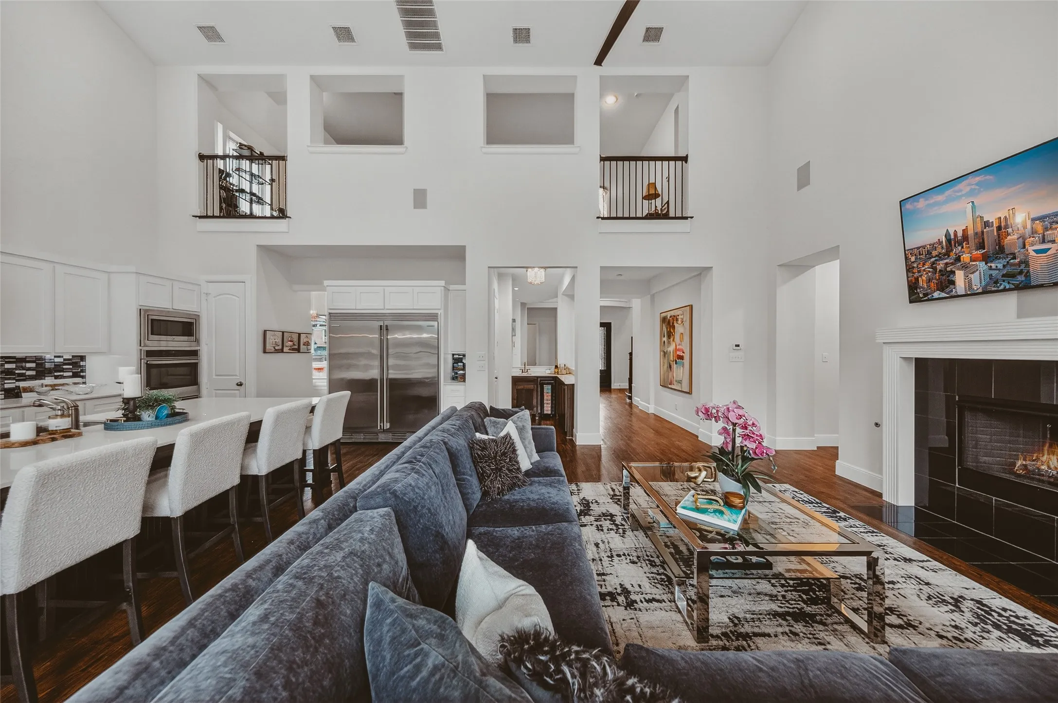 Grand living area featuring soaring ceilings and hardwood flooring