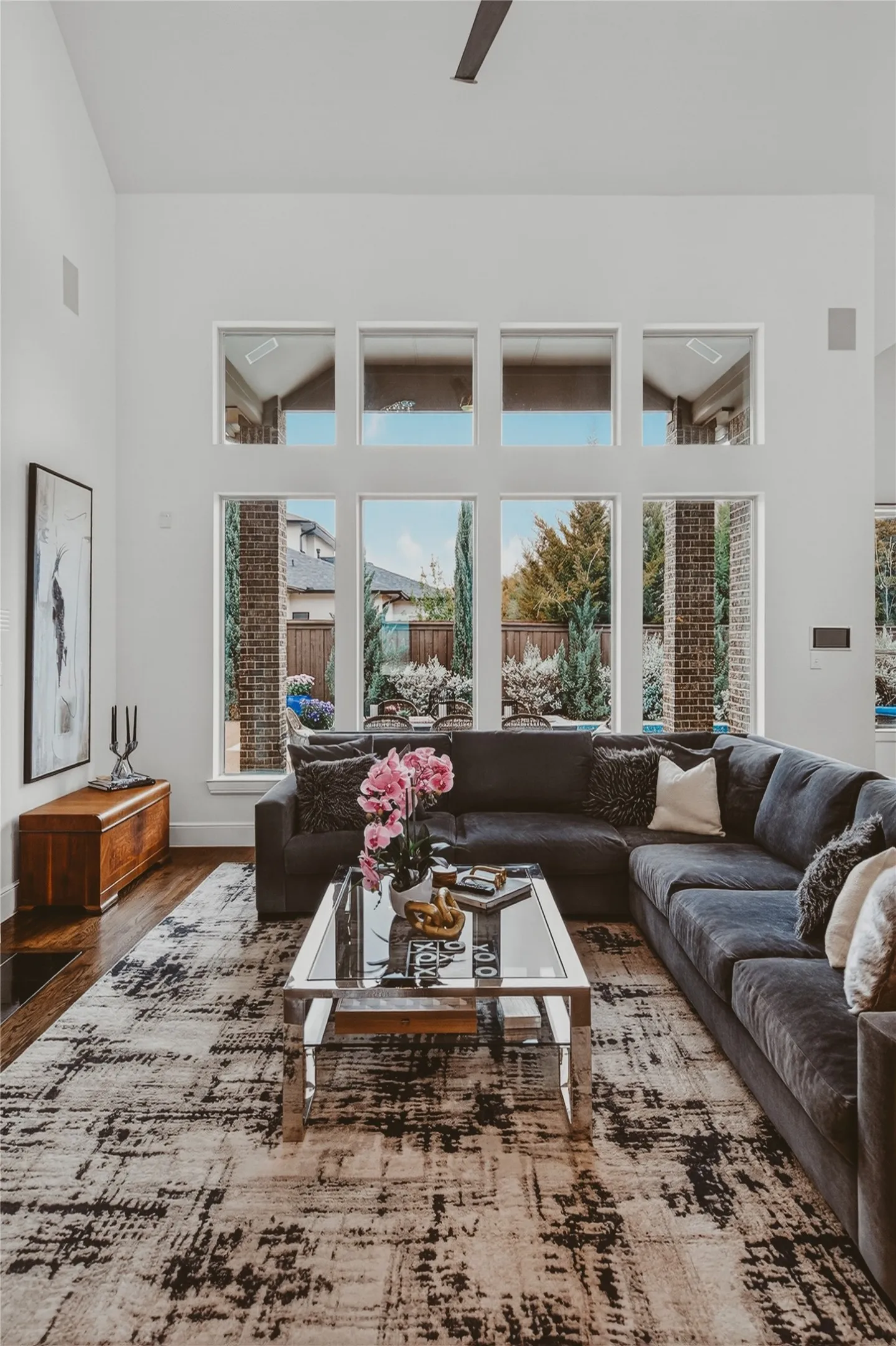 Living area featuring soaring ceilings and a grid of large windows