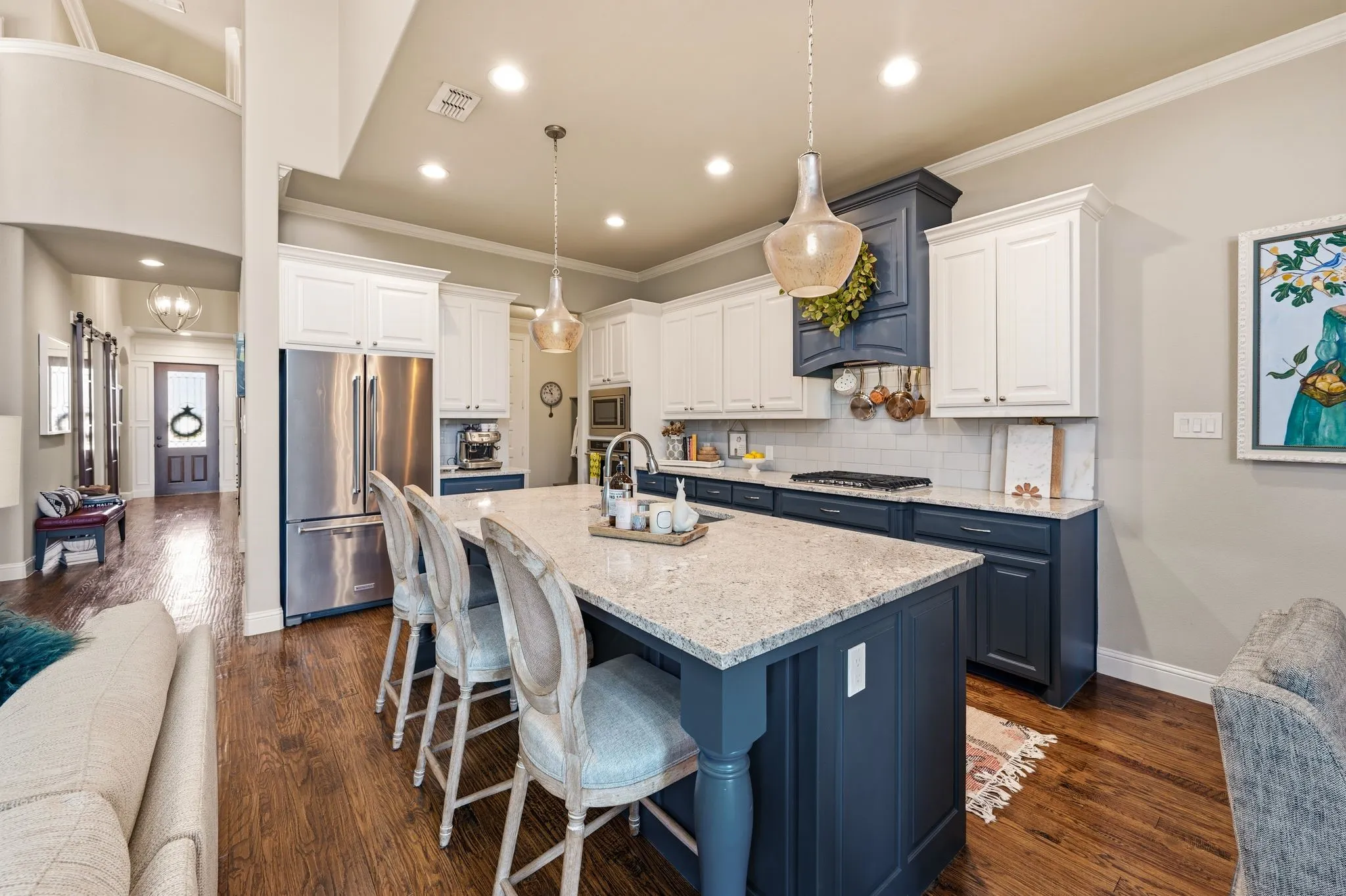 Kitchen opens to living room with large island