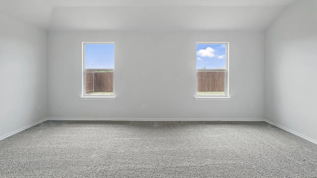 Spacious room with plush gray carpeting, white painted walls, and two windows