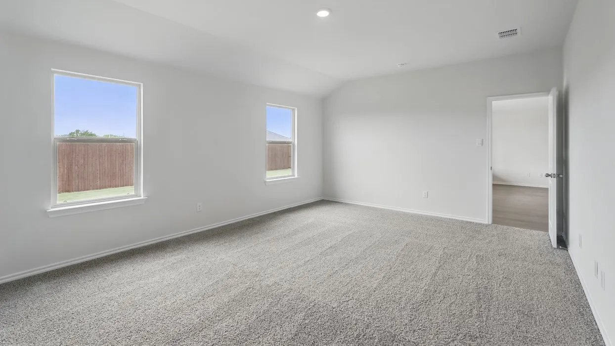 Spacious room featuring vaulted ceilings and recessed lighting
