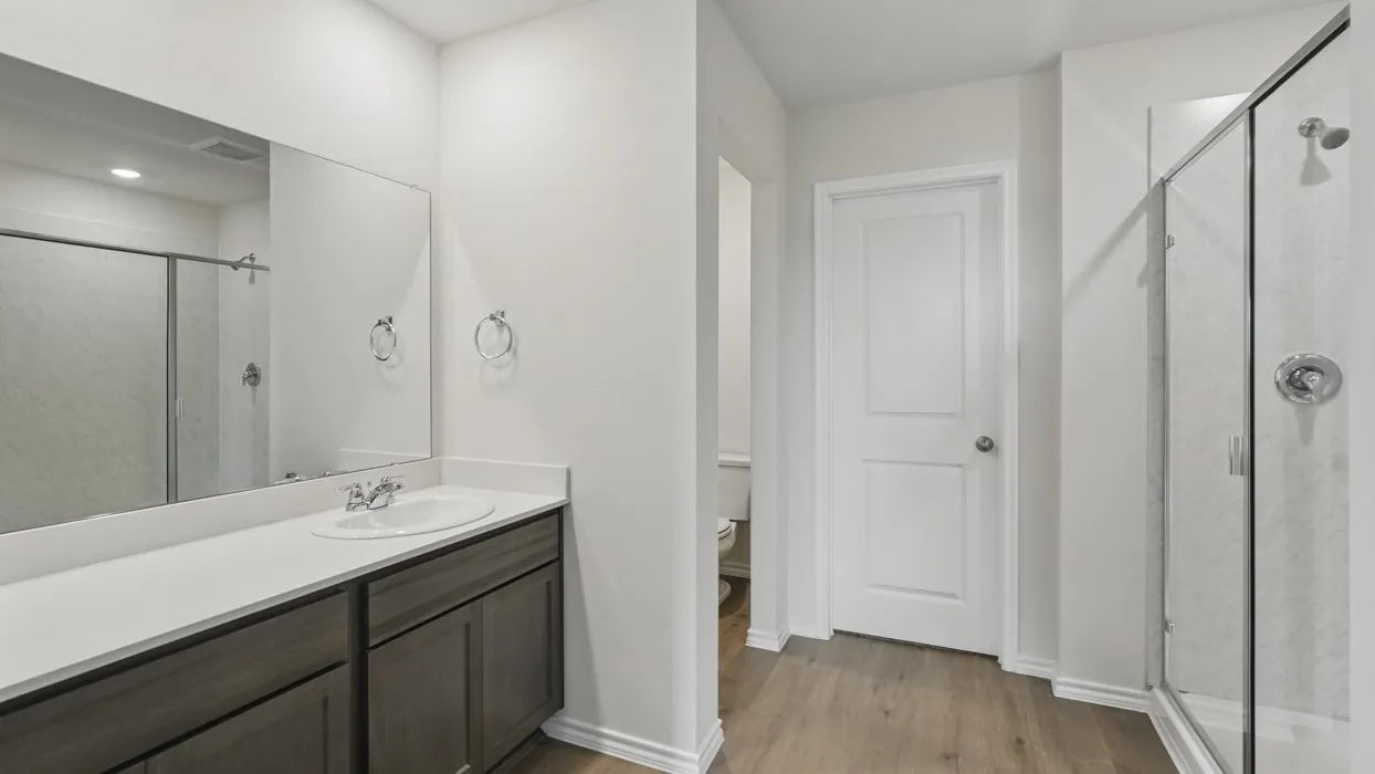 Bathroom featuring a vanity with dark wood-finish cabinetry, a white countertop, and an integrated sink
