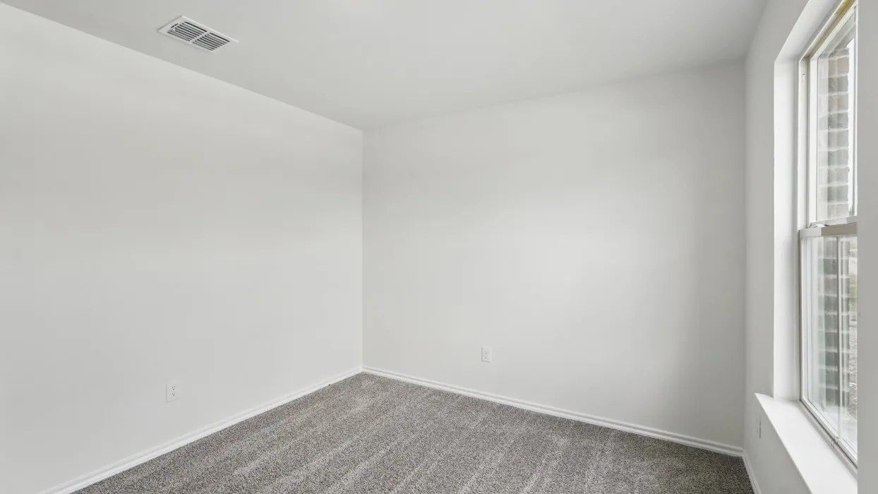 Bright room featuring light gray carpeting and white walls