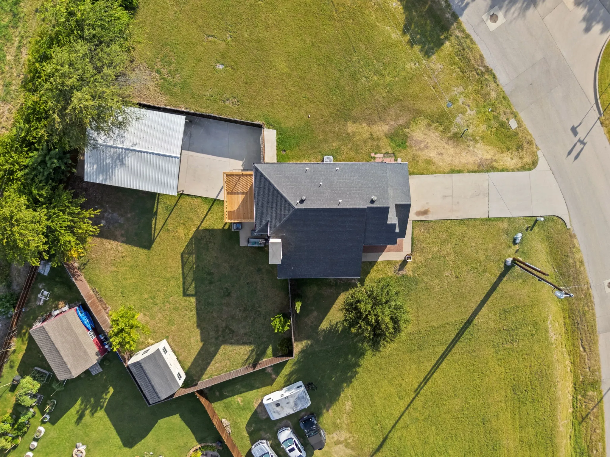 Aerial view showcasing a residential property with an expansive grassy yard