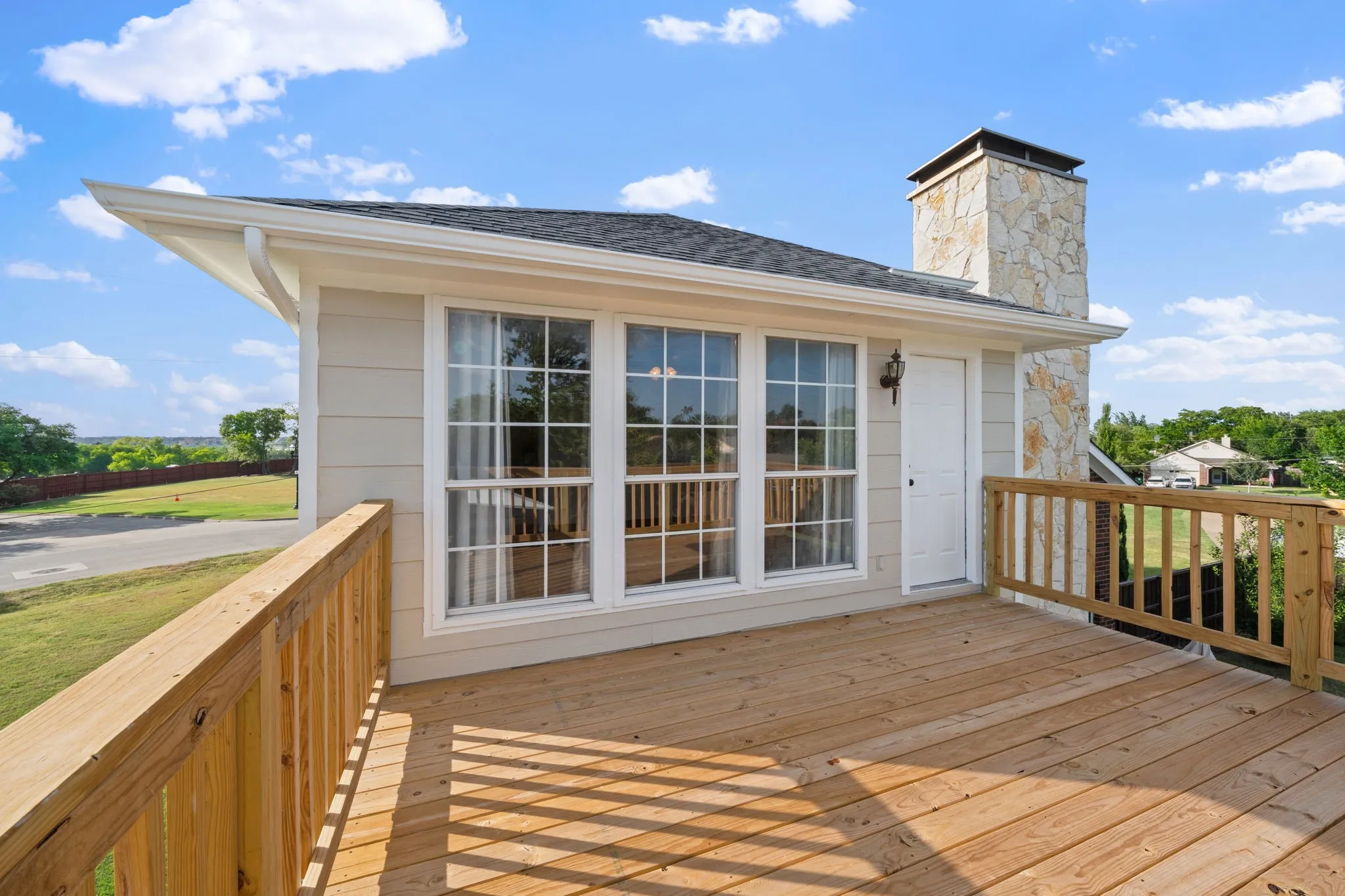 Expansive wooden deck with coordinating railings