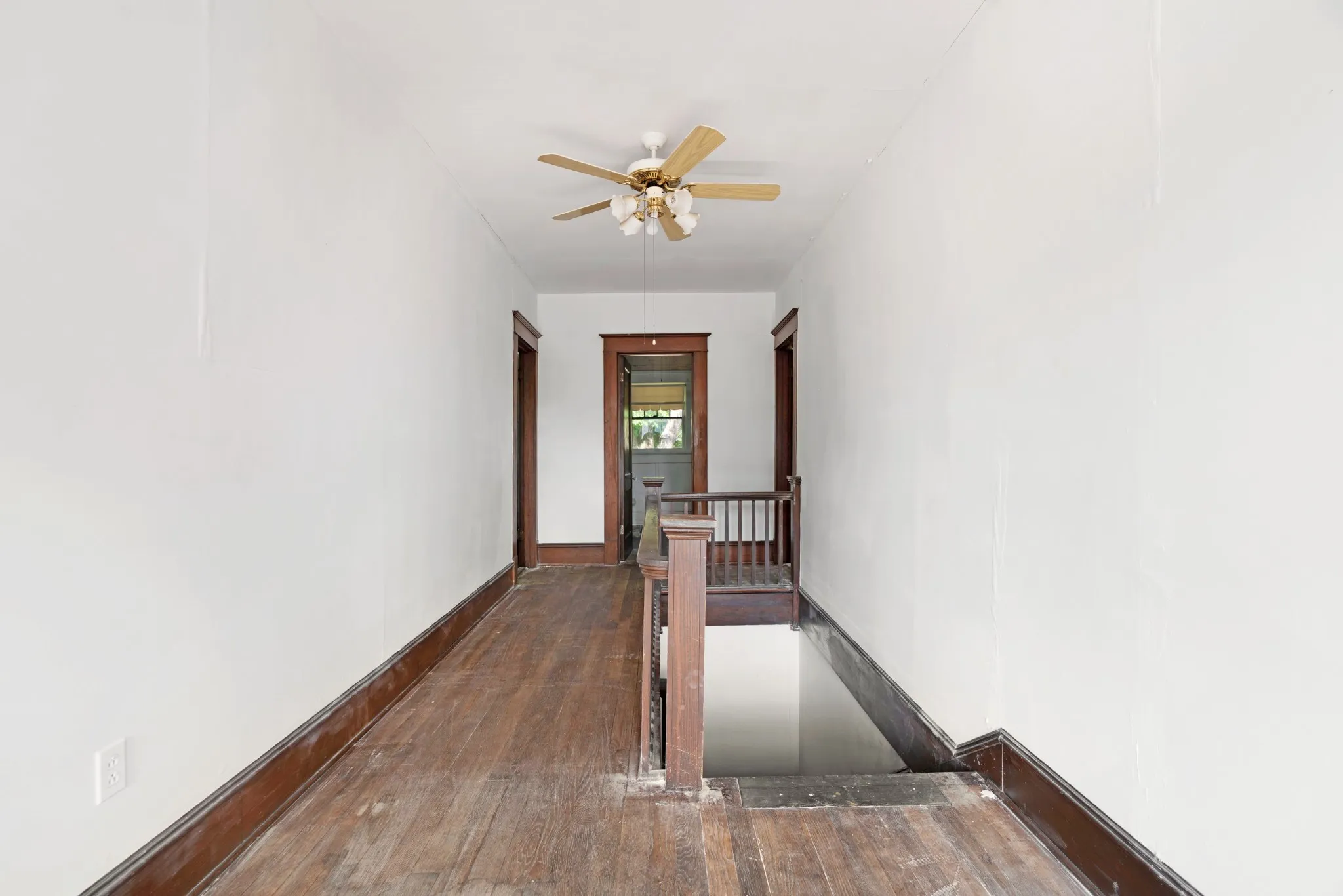 Entry of the stairs to the second floor with hardwood flooring