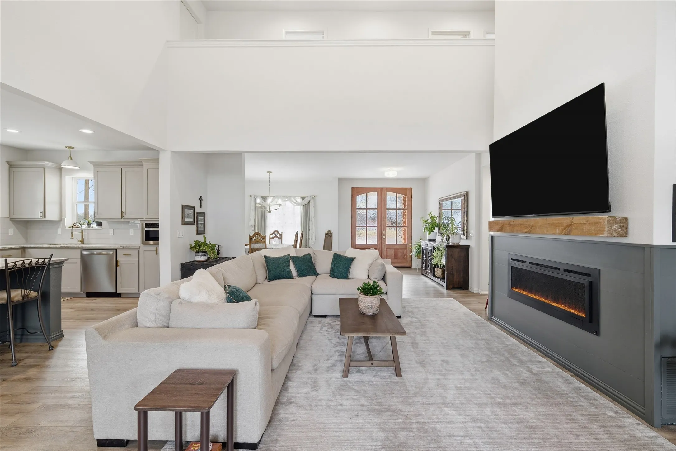 Open-concept living area featuring high ceilings and wood-finish flooring