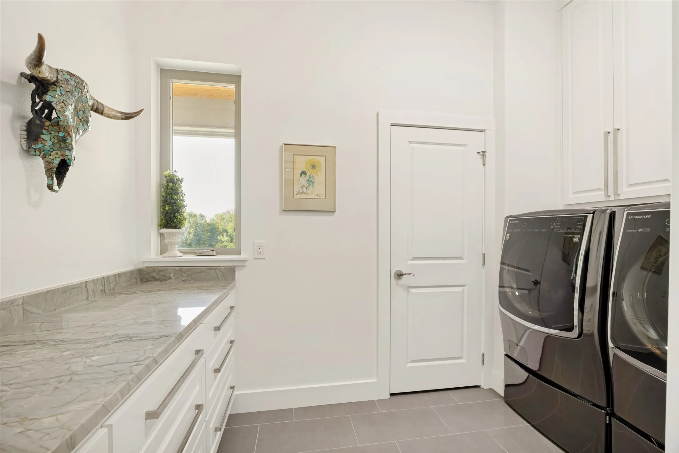 Laundry with sink and bonus room with safe