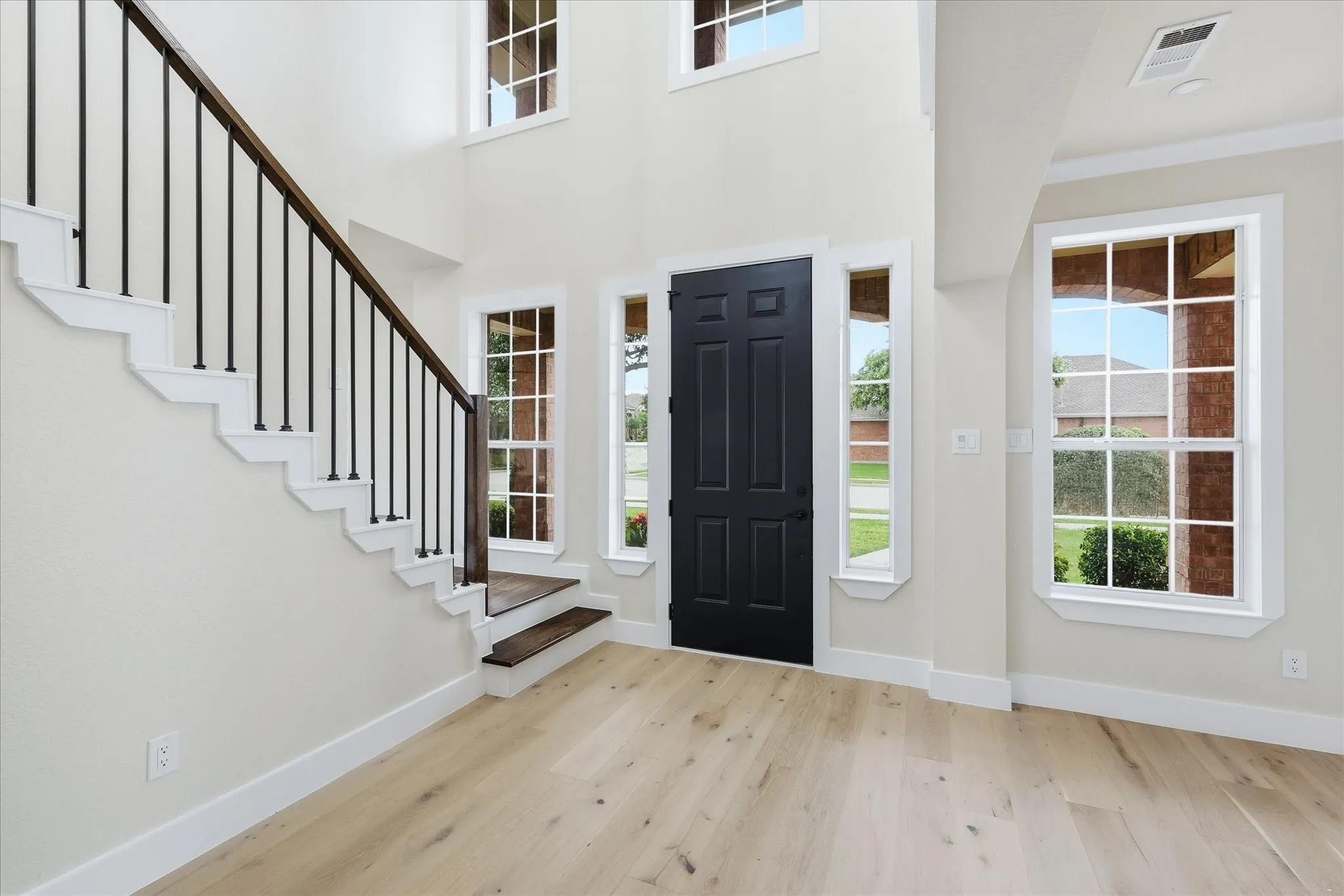 Foyer has tall ceilings and updated flooring