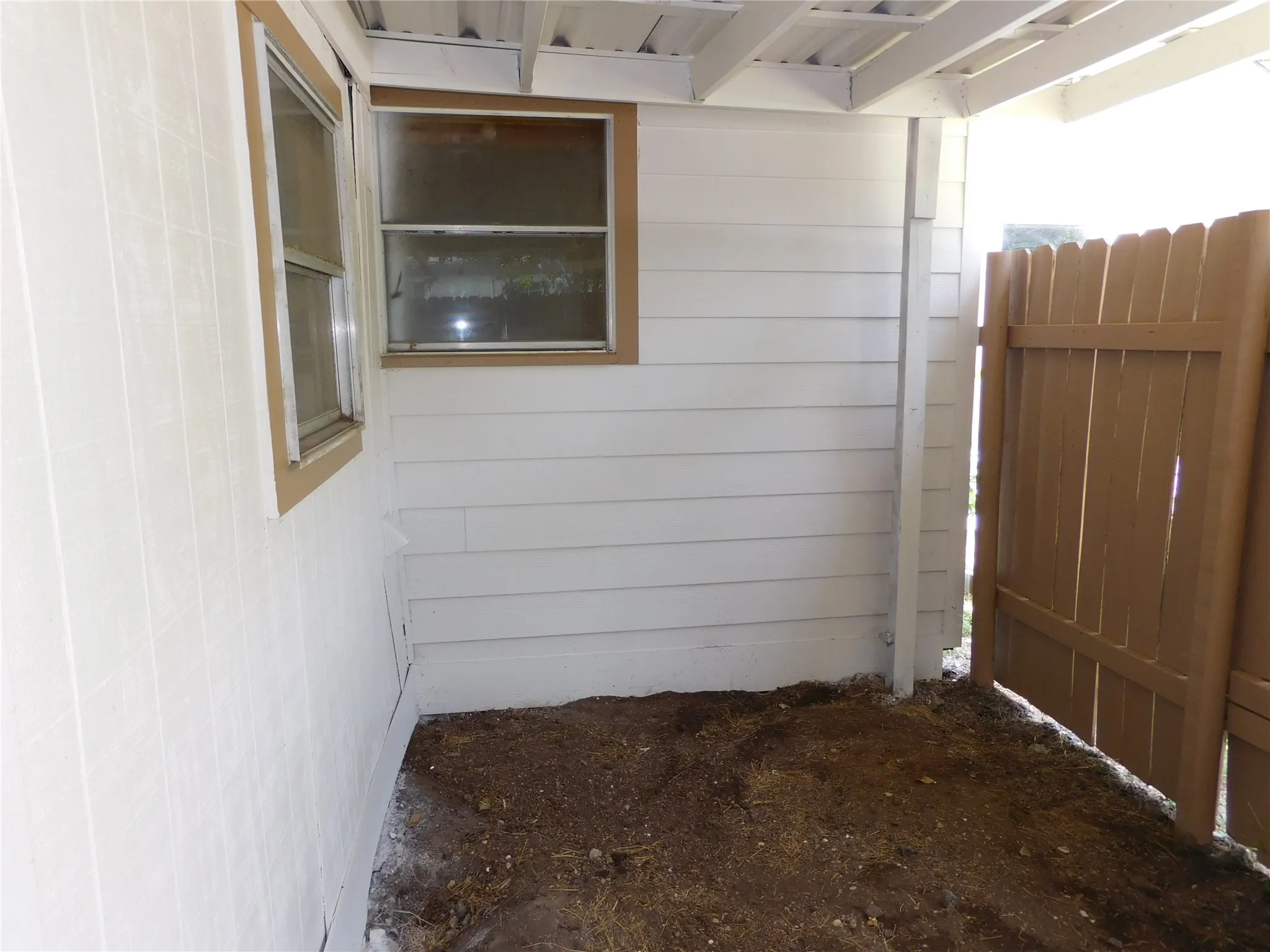 storage area under carport for lawn care items