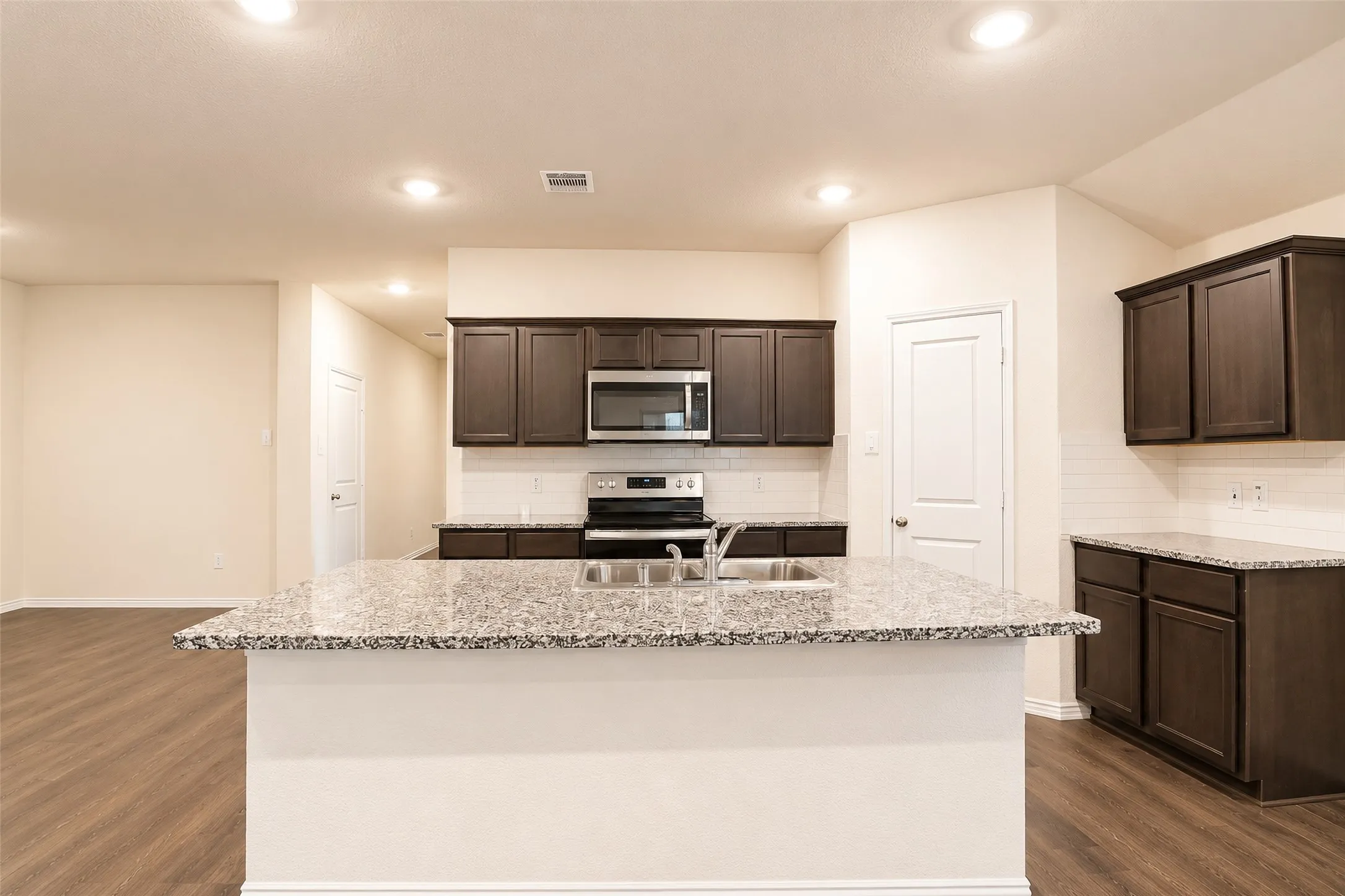 Kitchen island with a granite-style countertop and double basin sink