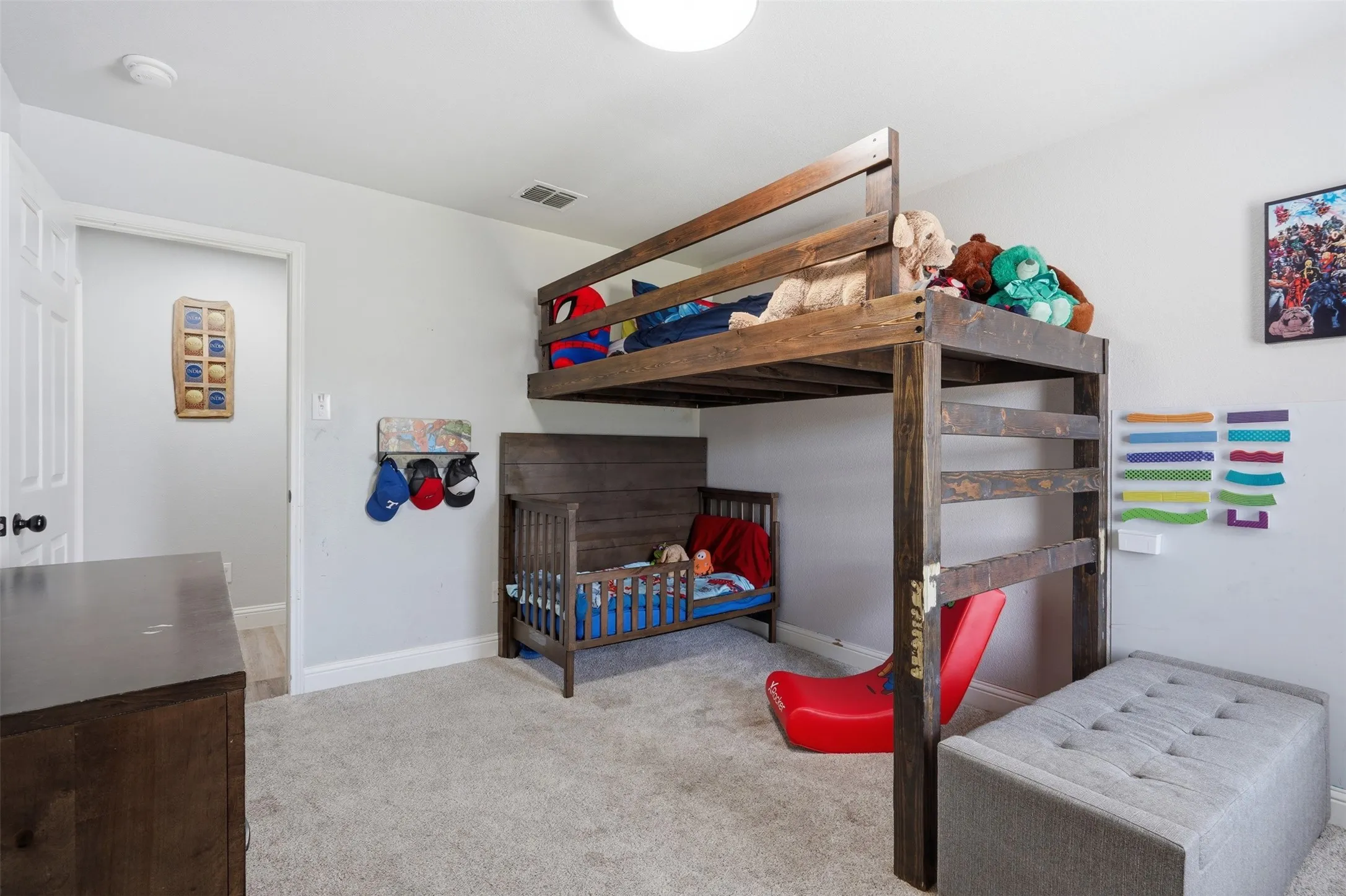 Light gray walls with white trim and gray carpeting