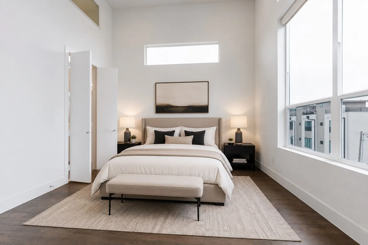 Spacious room featuring high ceilings, dark wood-finish flooring, and expansive windows with roller shades
