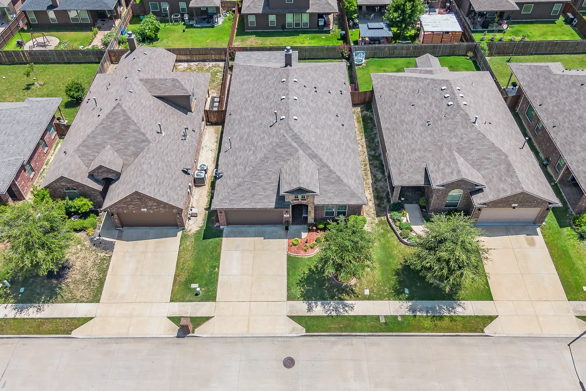 Single-story residence featuring a brick facade with stone accents, a two-car garage, and a manicured front lawn