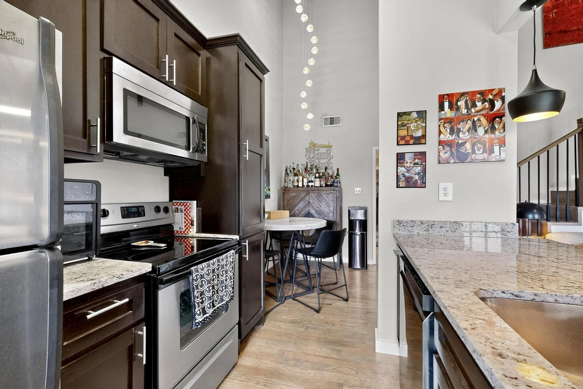 Kitchen featuring granite countertops, dark wood cabinetry, and stainless steel appliances