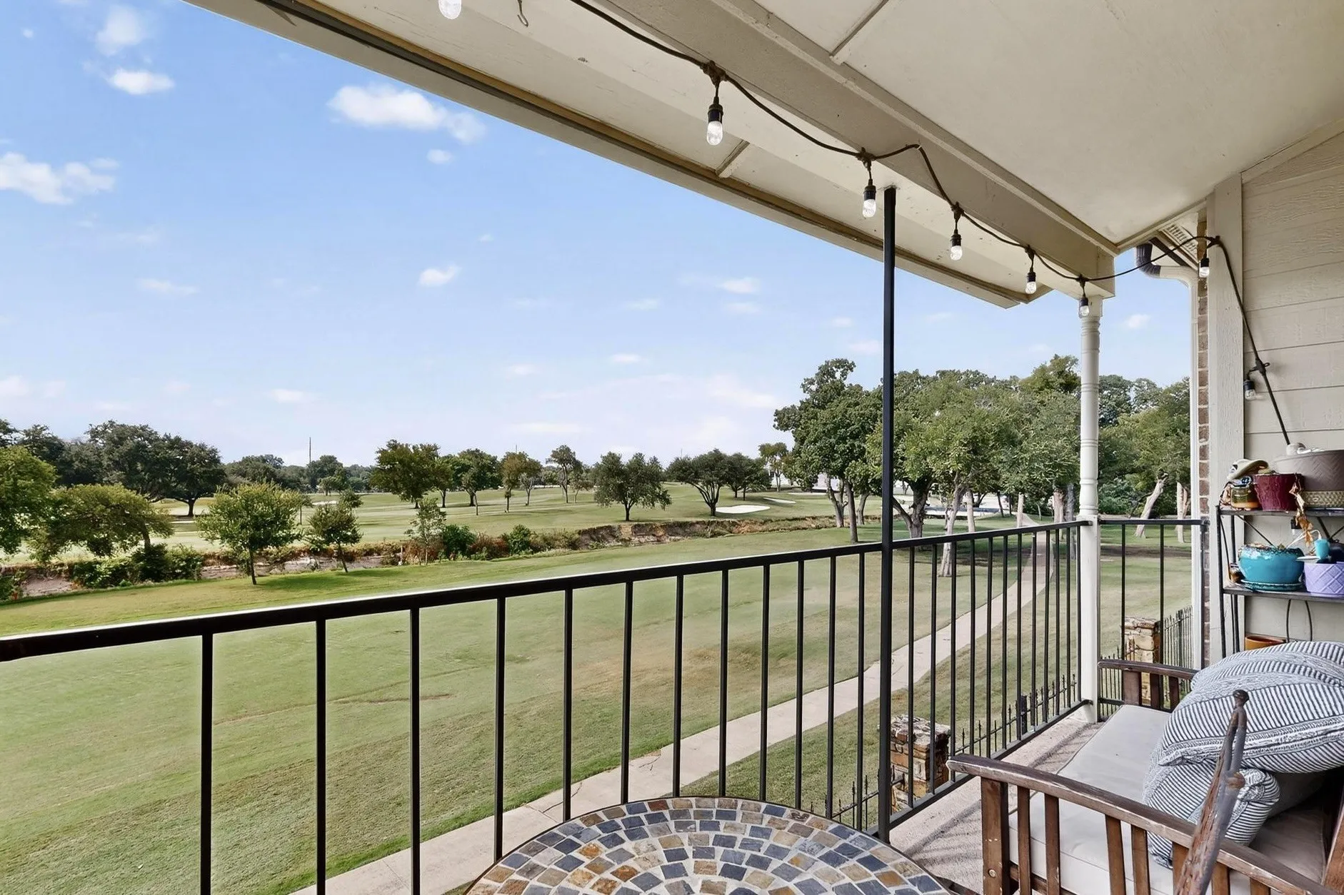 Private outdoor balcony with a golf course backdrop