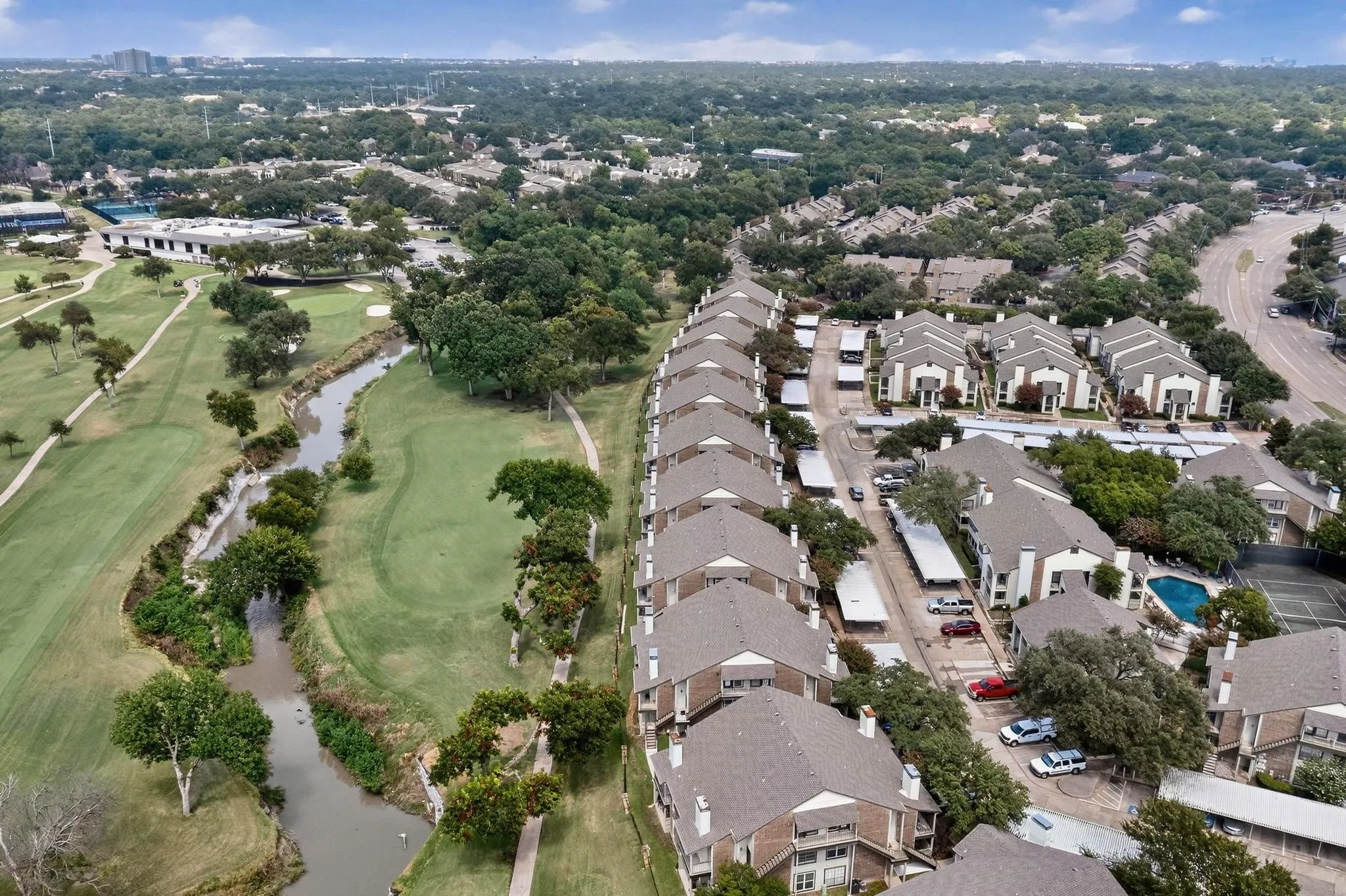 Aerial perspective showcasing apartment buildings adjacent to a golf course