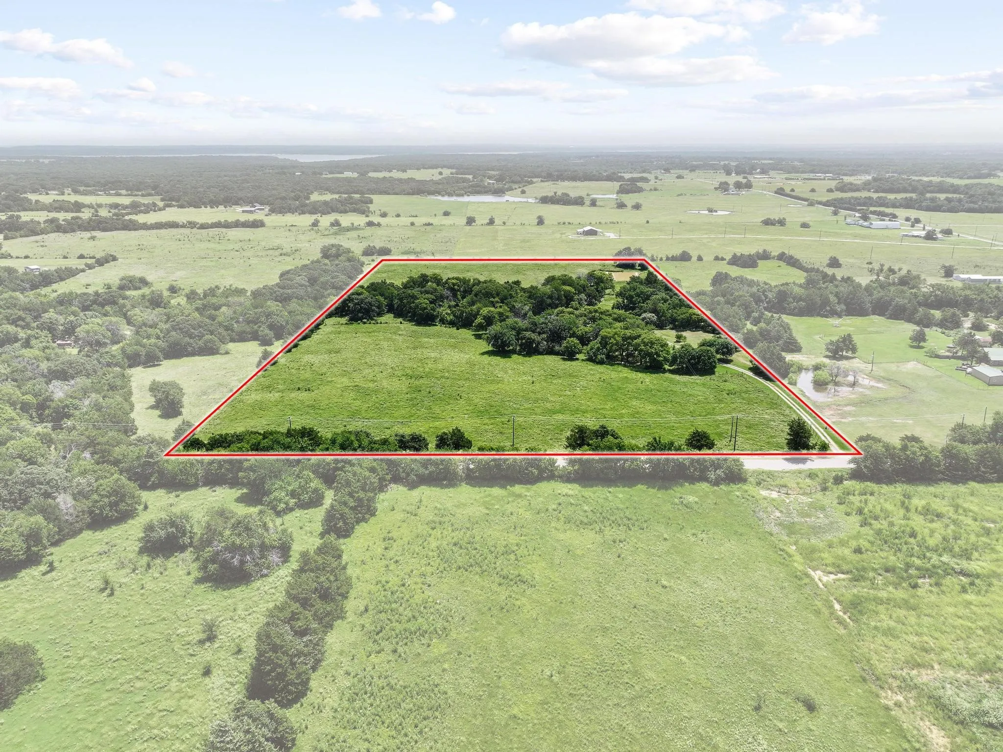 20 acre land parcel featuring a combination of open grasslands and mature tree clusters