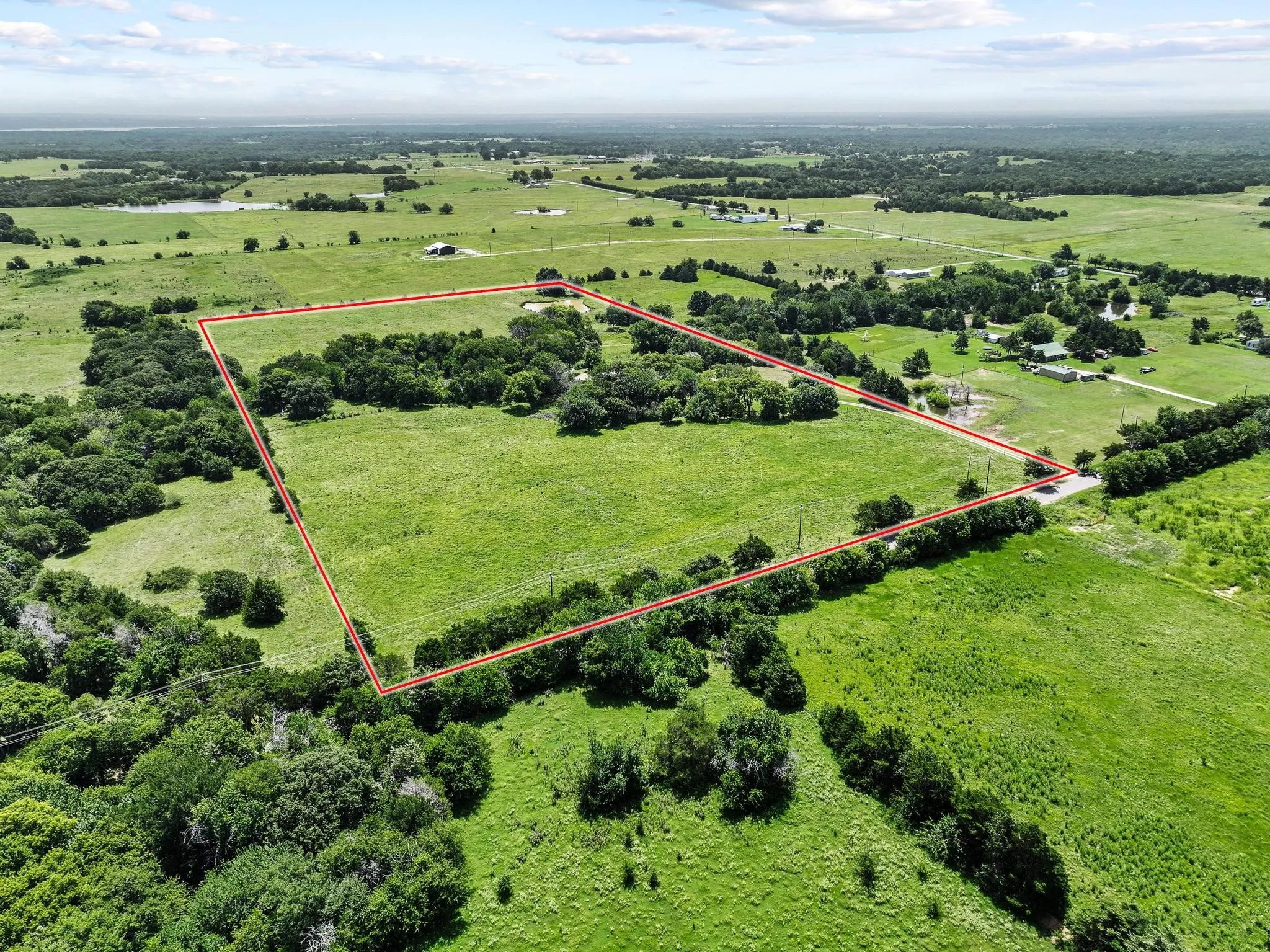 20 acres featuring a mix of open fields and mature tree lines