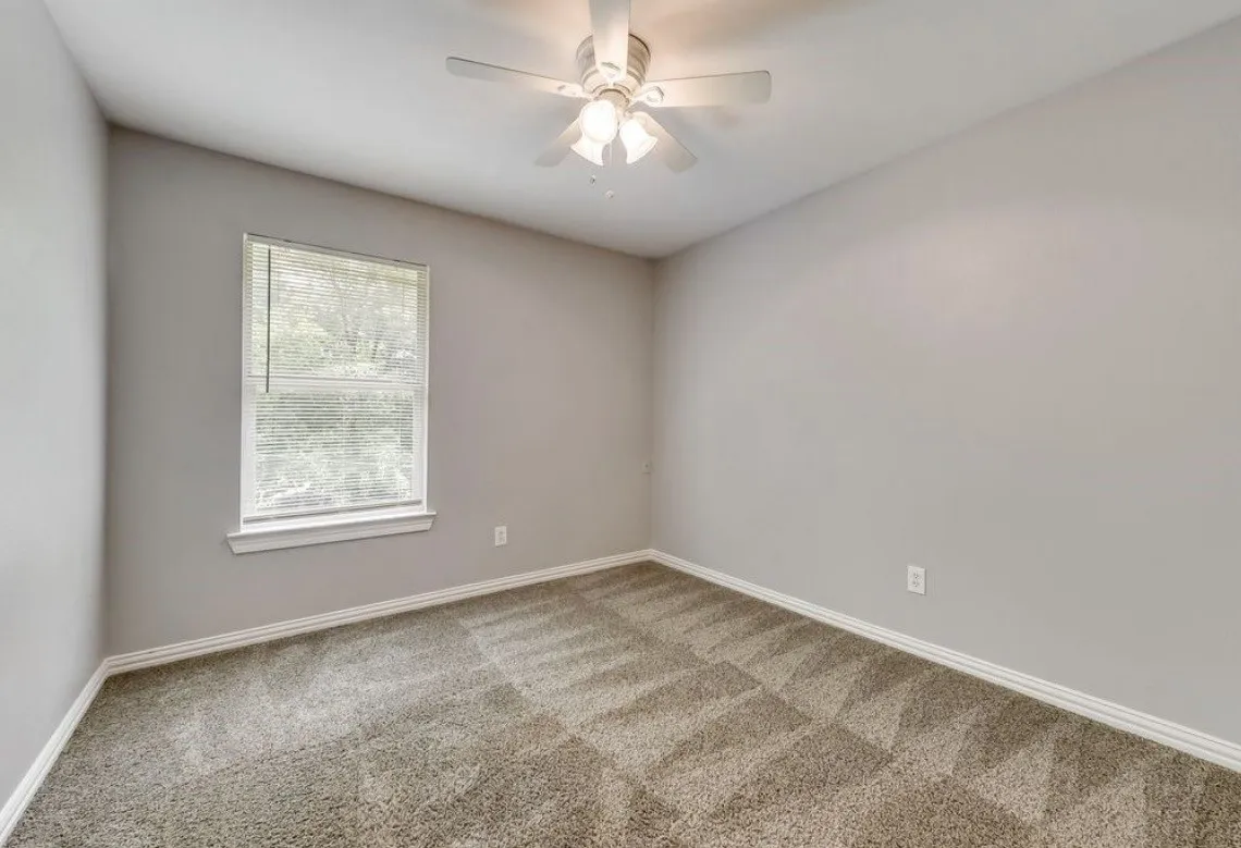Room #3 featuring light neutral walls, textured carpet, and a white ceiling fan with light fixture