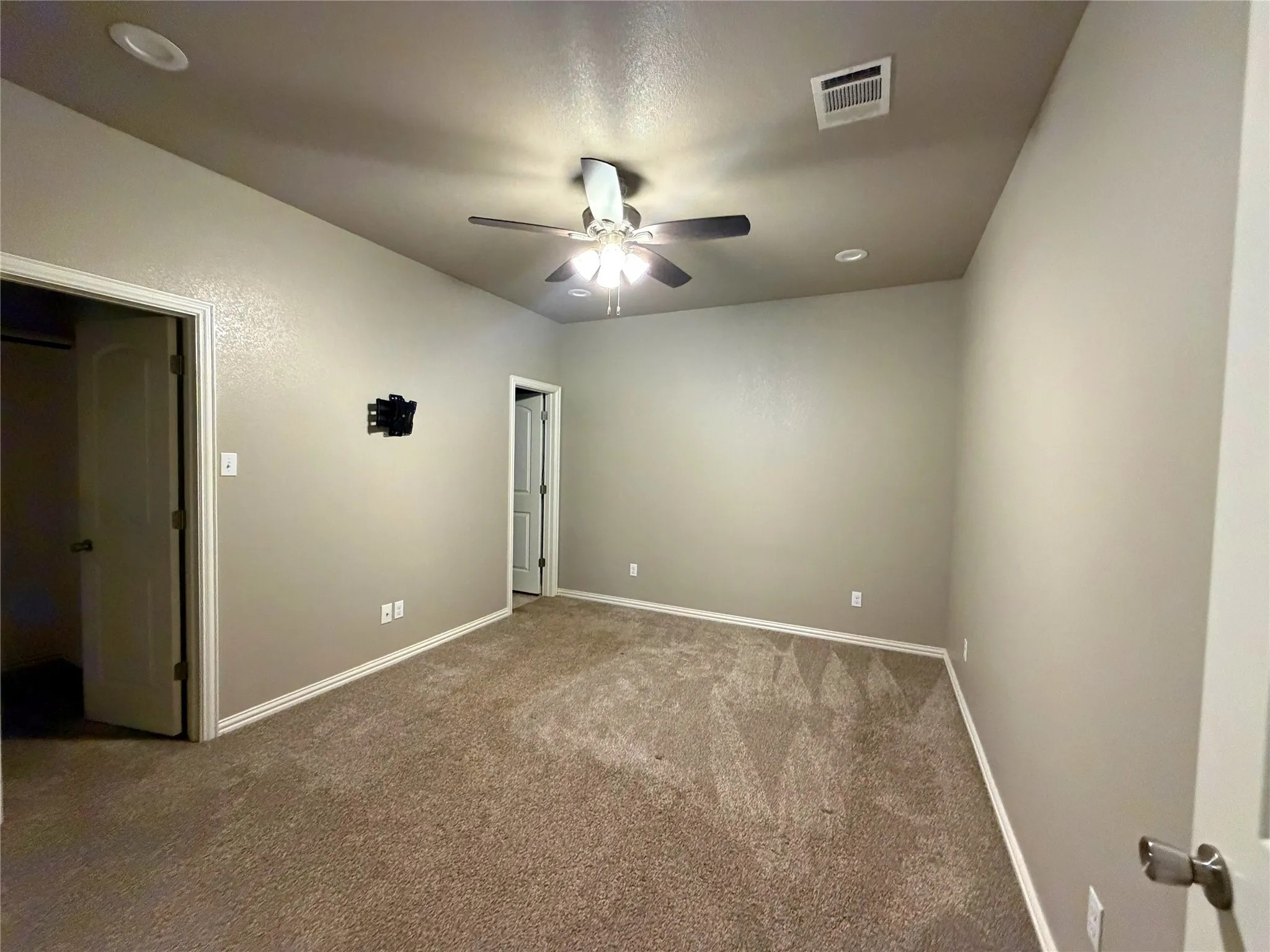 Carpeted room featuring a ceiling fan with integrated lighting, recessed lighting, and neutral tone walls