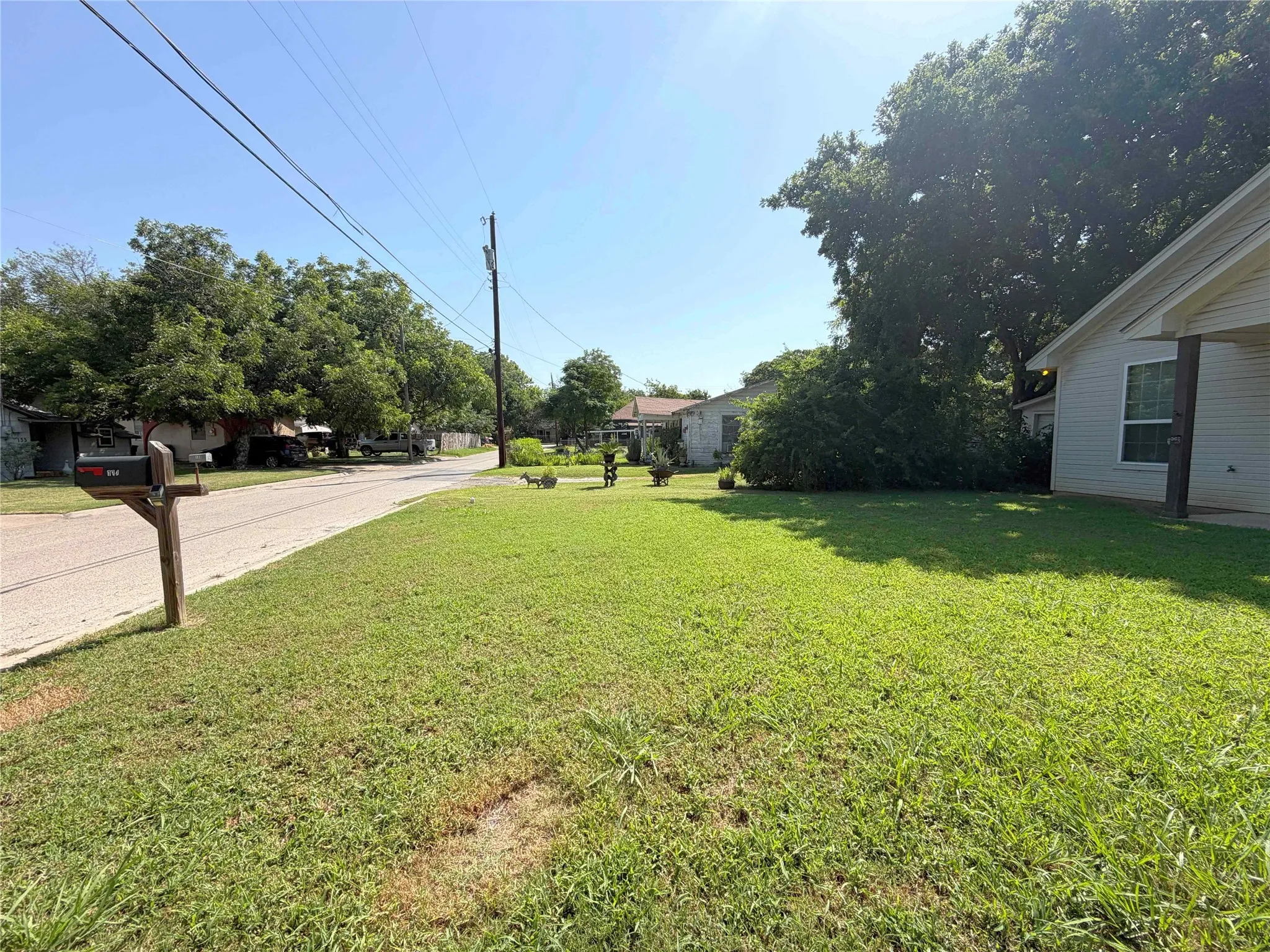 Expansive front yard with a green lawn