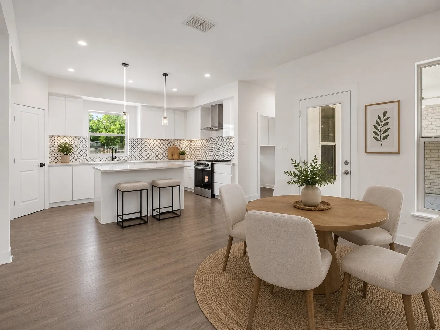 Open-concept kitchen and dining area featuring wood-finish flooring, recessed lighting, and a white tile backsplash