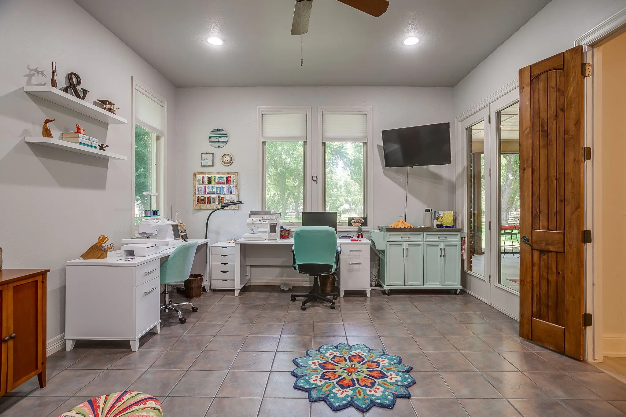 Oversized bedroom could serve as a secondary primary, game room, flex space with outdoor access and decorative wood door entrance to the main living space