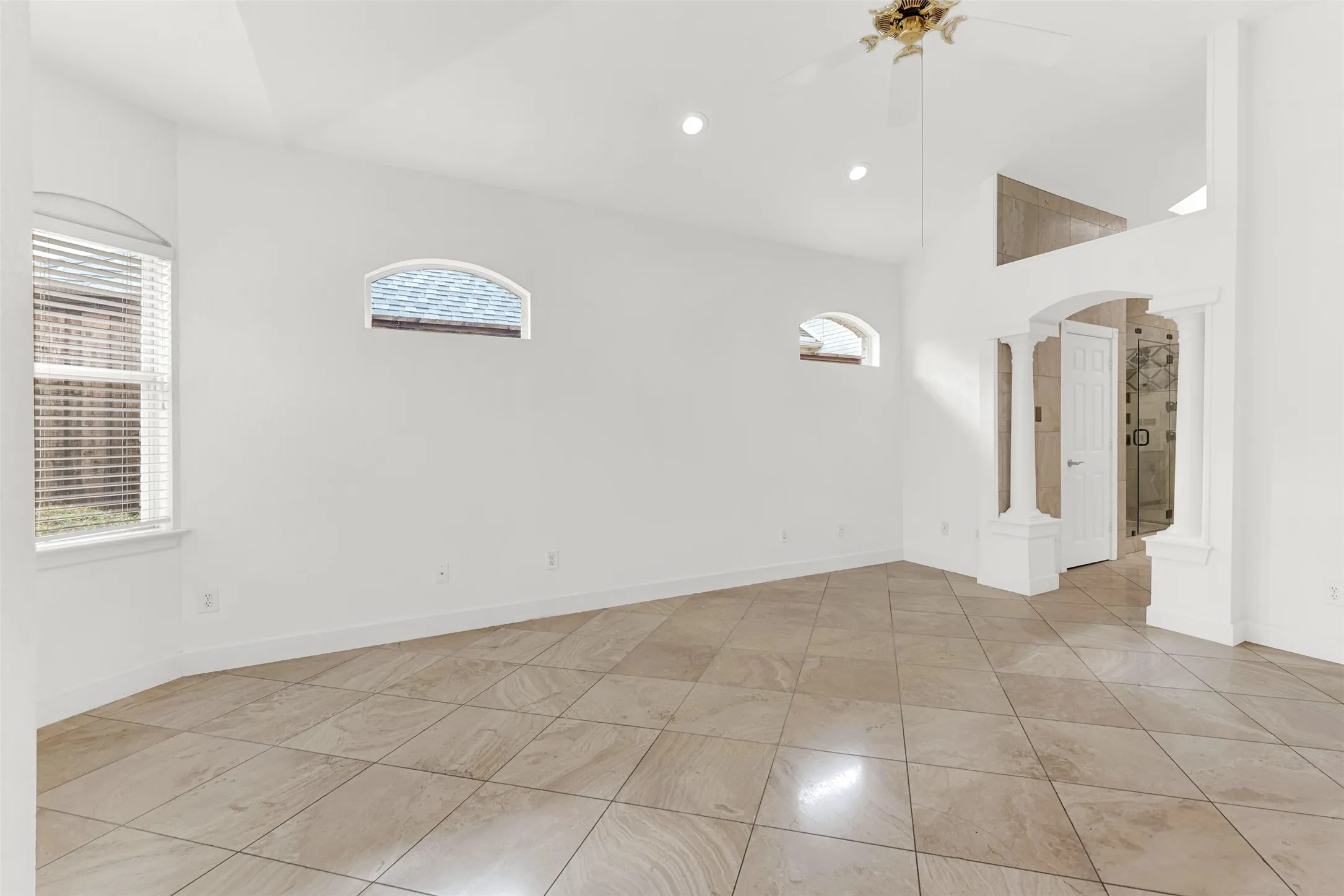 A classical columned archway frames a dramatic peek into the adjoining suite, creating a grand sense of entry. Slip away after a long day through this elegant passage to enjoy a peaceful, spa-like evening soak.