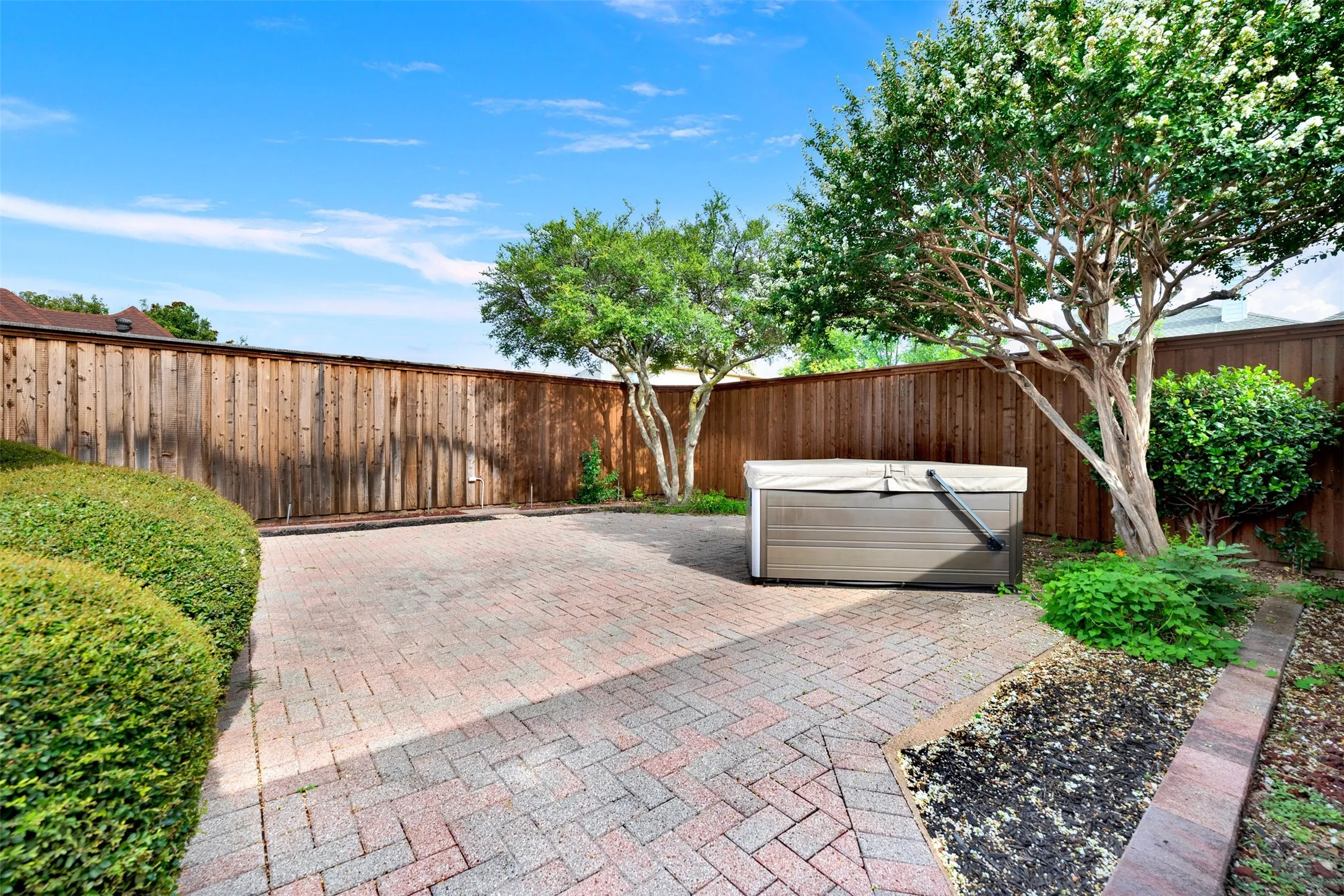 Mature, leafy trees cast cool, dancing shadows across the open courtyard space throughout the afternoon. It is an ideal setting to host a casual weekend gathering where friends can comfortably chat in the shade.