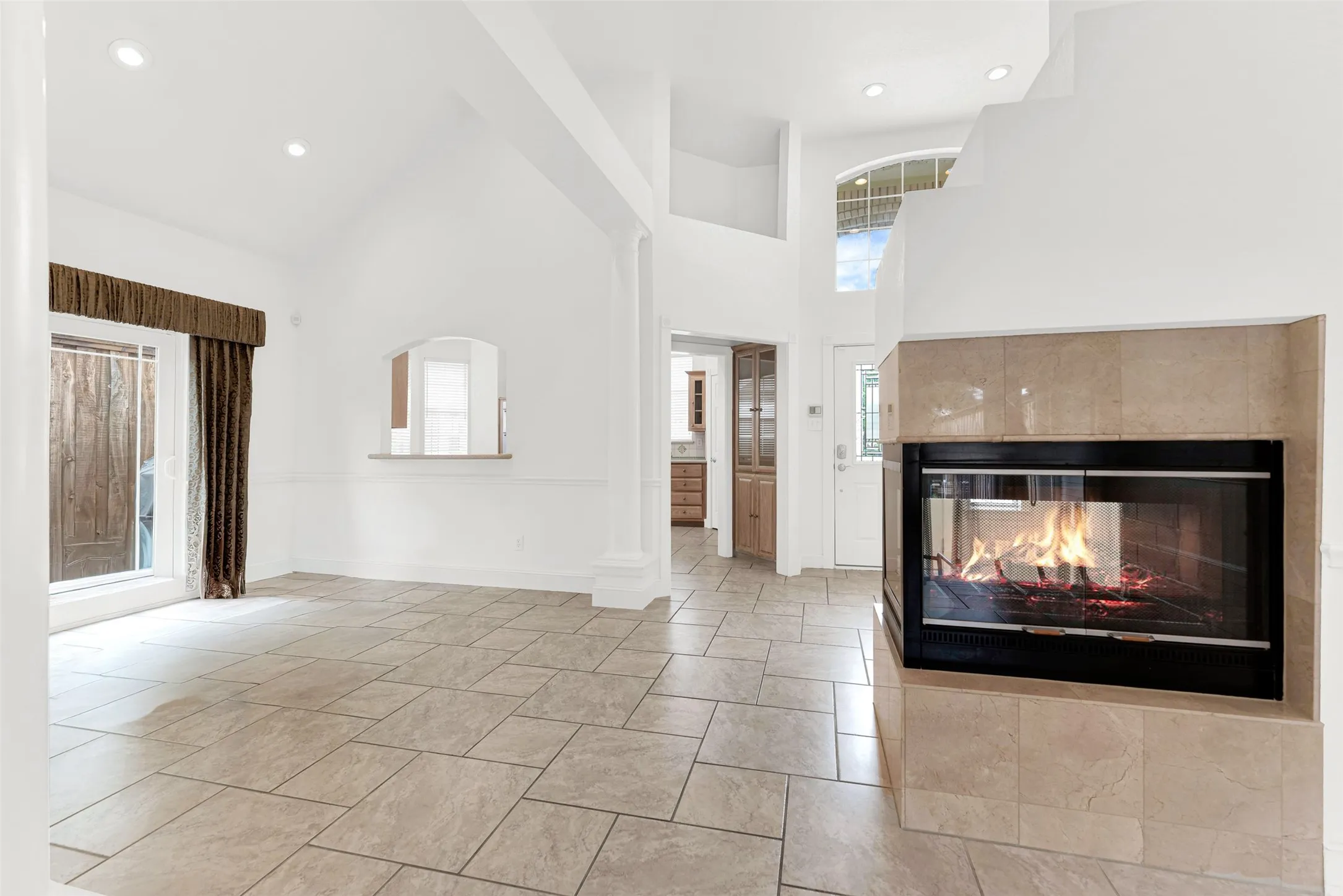 The unique, multi-sided fireplace serves as a sculptural centerpiece that warms multiple rooms simultaneously. Visualize the family gathering around the fire on a chilly winter night to share stories and laughter.