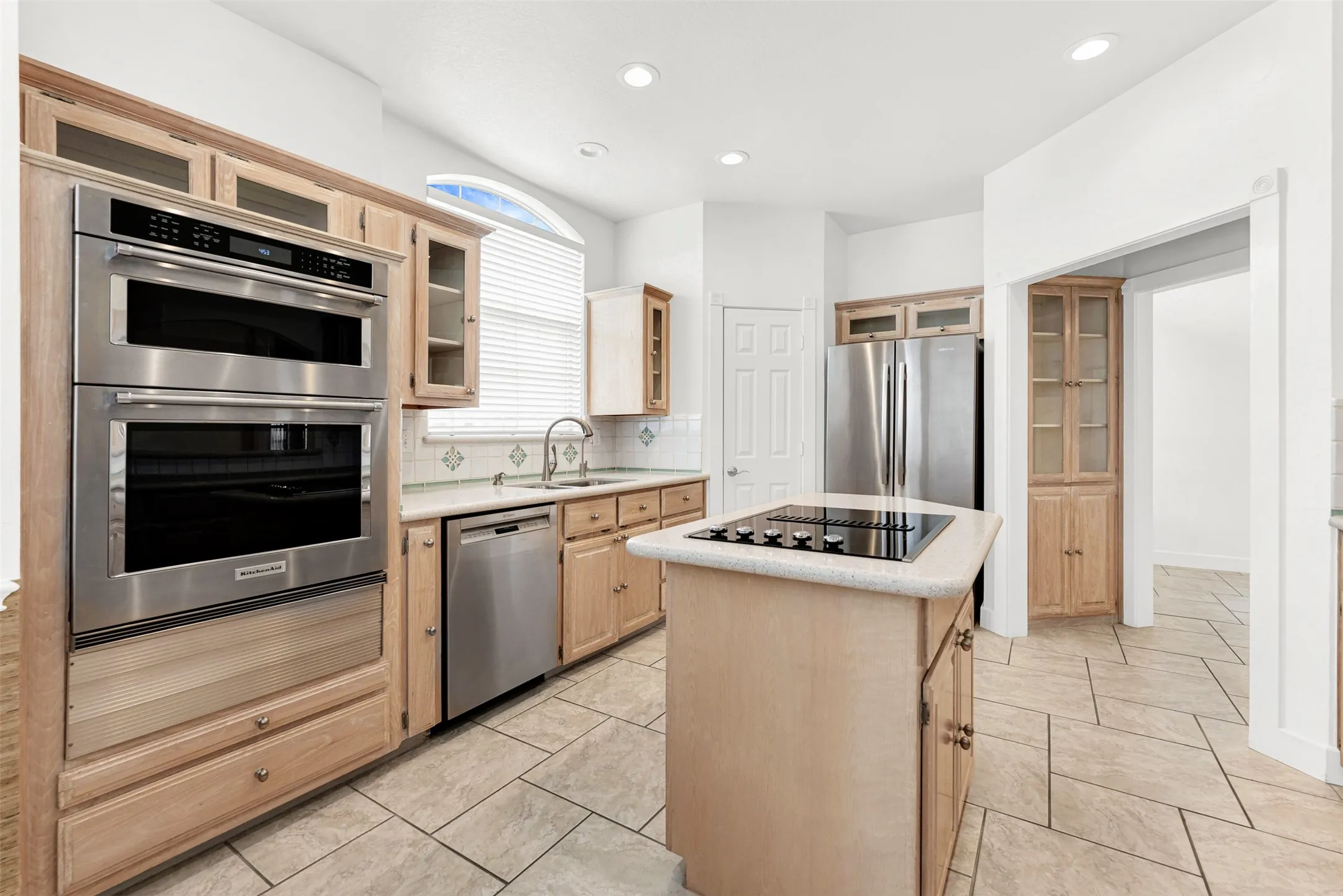 The built-in stainless steel oven and microwave anchor the custom cabinetry layout with strong, clean lines. Picture baking sweet treats with the kids on a relaxed Sunday afternoon