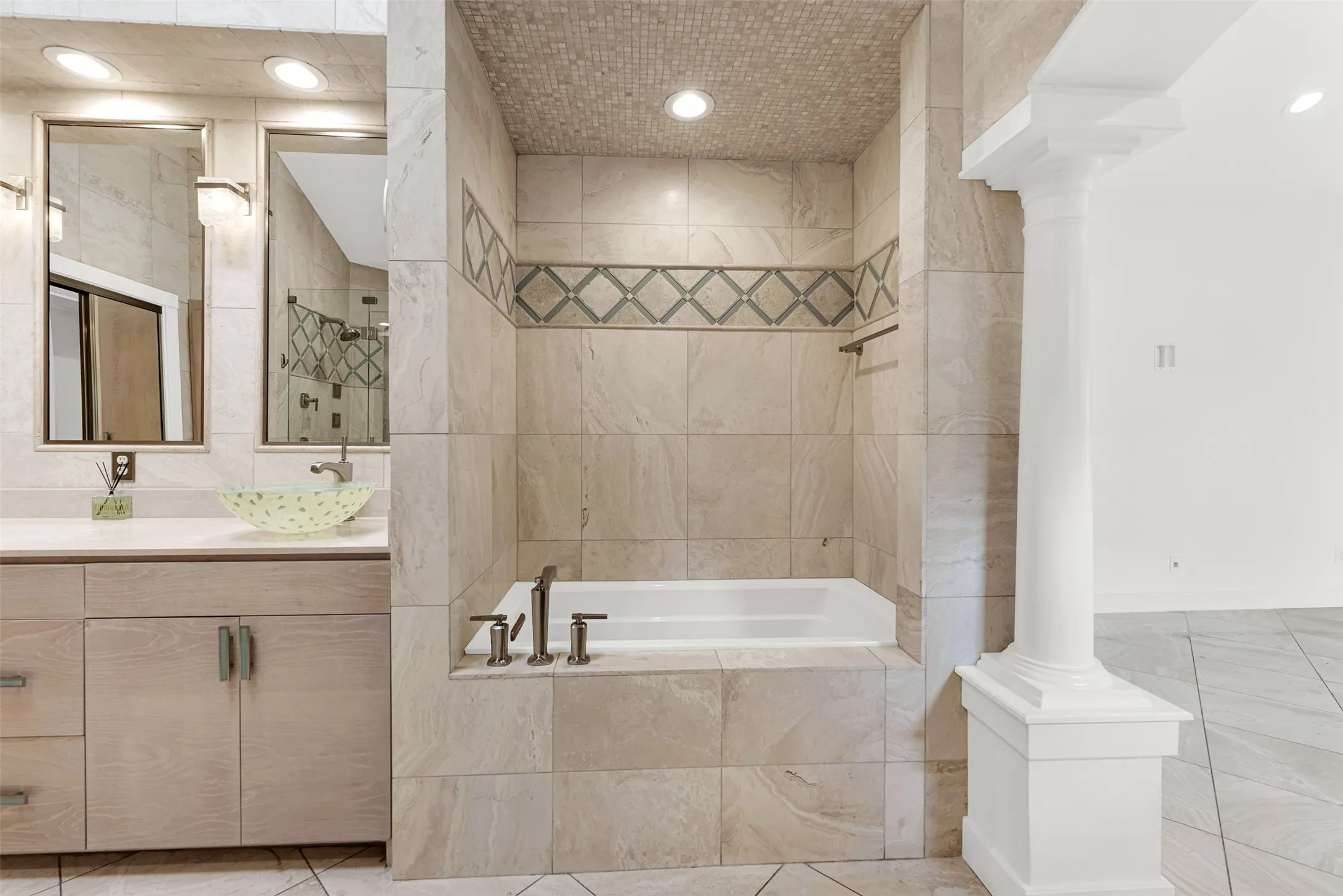 A deep soaking tub is nestled into an intimate tiled alcove accented with diamond-patterned trim. Draw a warm bath at twilight and let the worries of the workweek melt away in your private grotto.