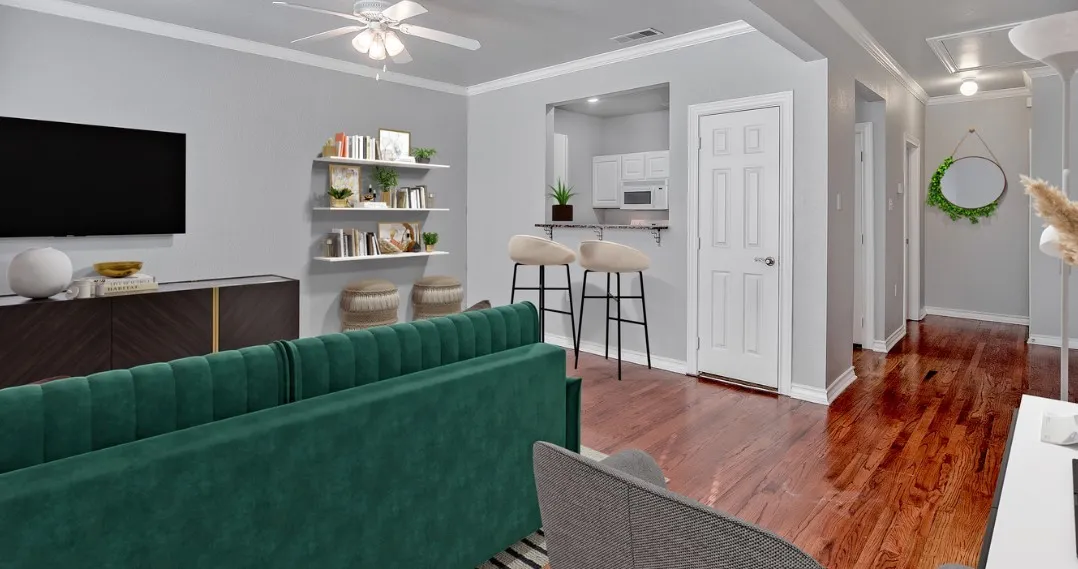 Open-concept living space featuring wood-finish flooring, a ceiling fan, and white floating shelves