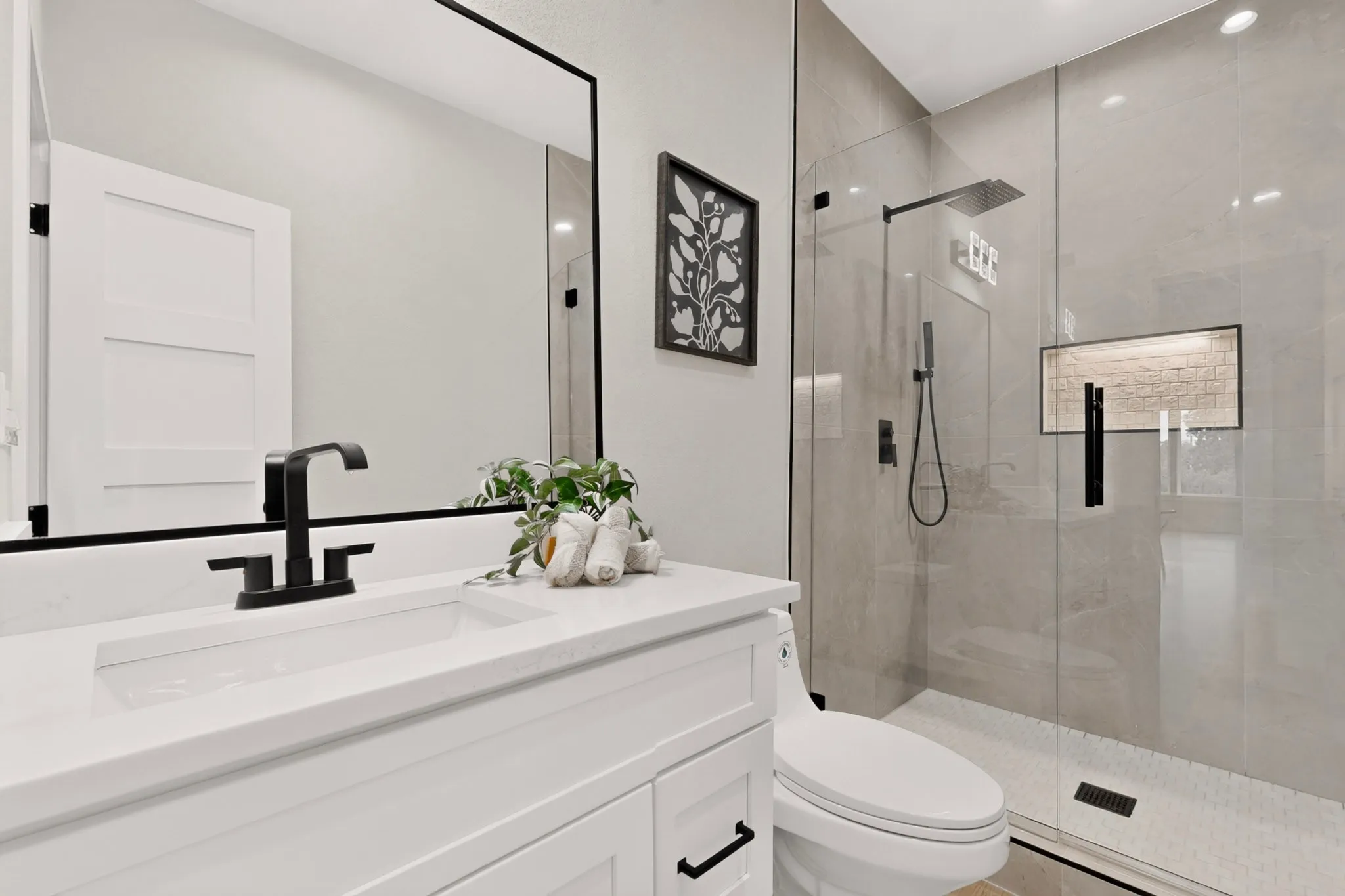 White vanity with integrated rectangular sink and matte black faucet