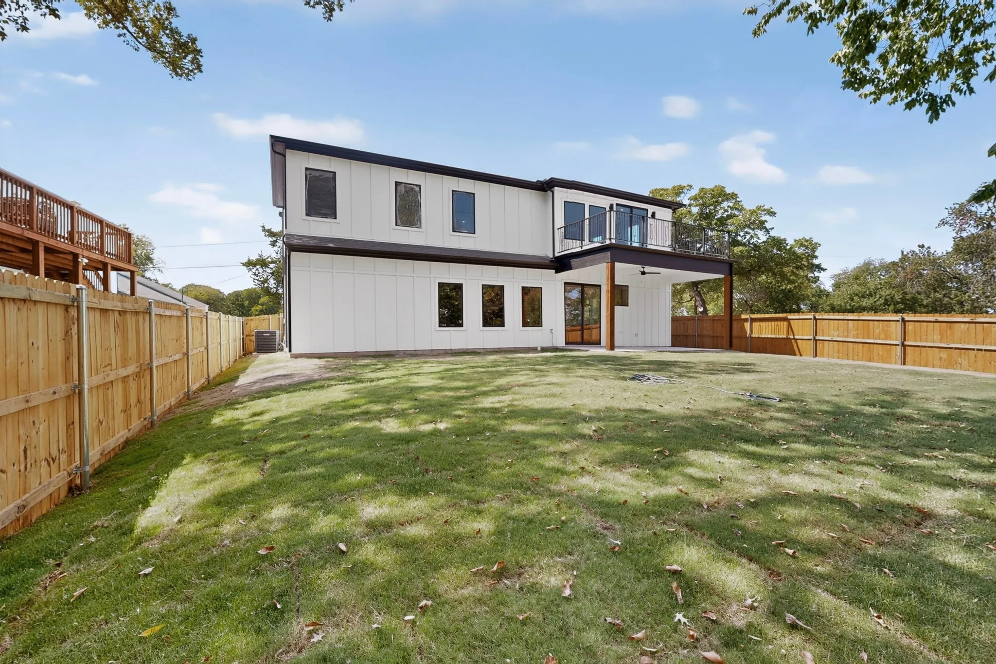 Contemporary architectural design with white vertical siding and black trim