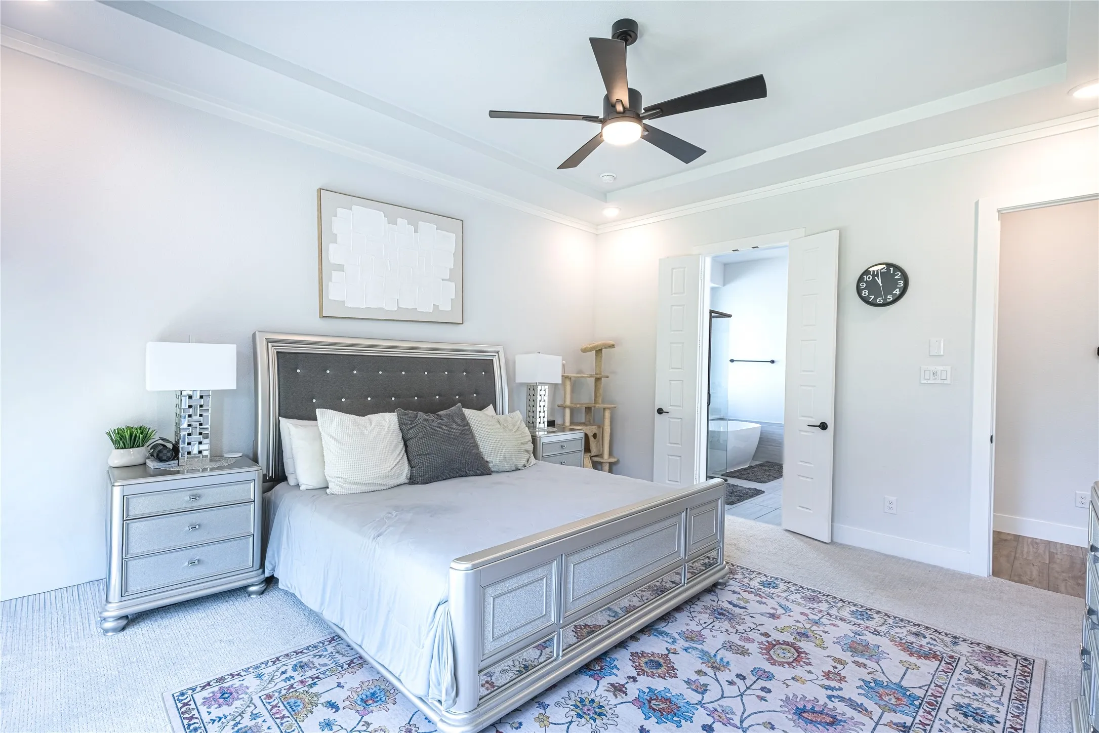 Recessed lighting illuminates a tray ceiling and crown molding
