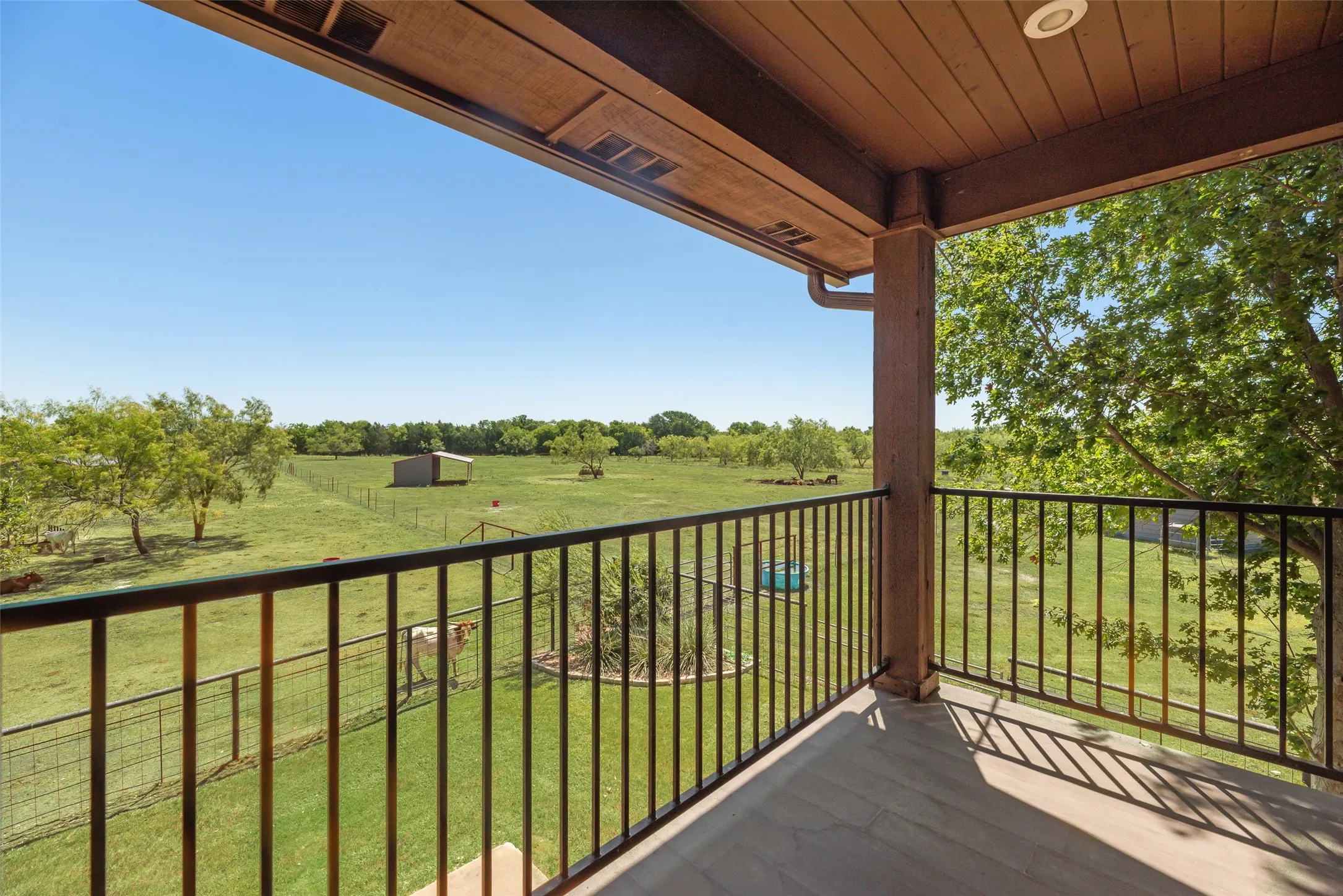 Balcony featuring dark railing, wood-finish flooring, and a recessed ceiling light