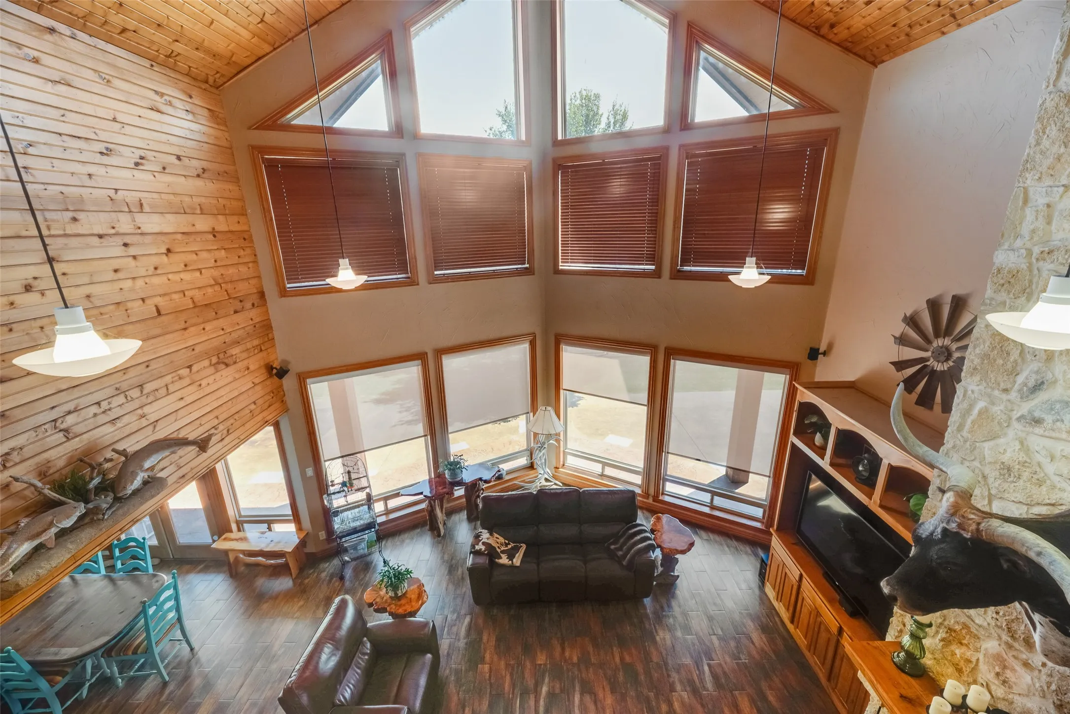 Soaring ceilings featuring extensive wood paneling and large window arrays