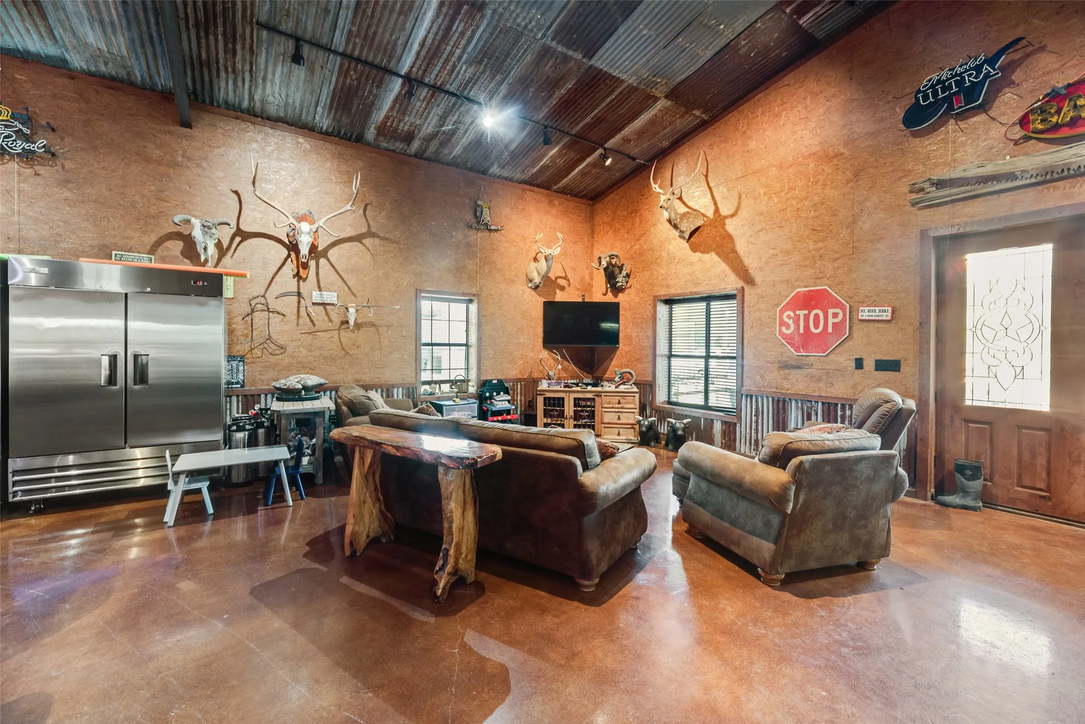 Open concept party area with great lighting, textured walls, and polished concrete flooring