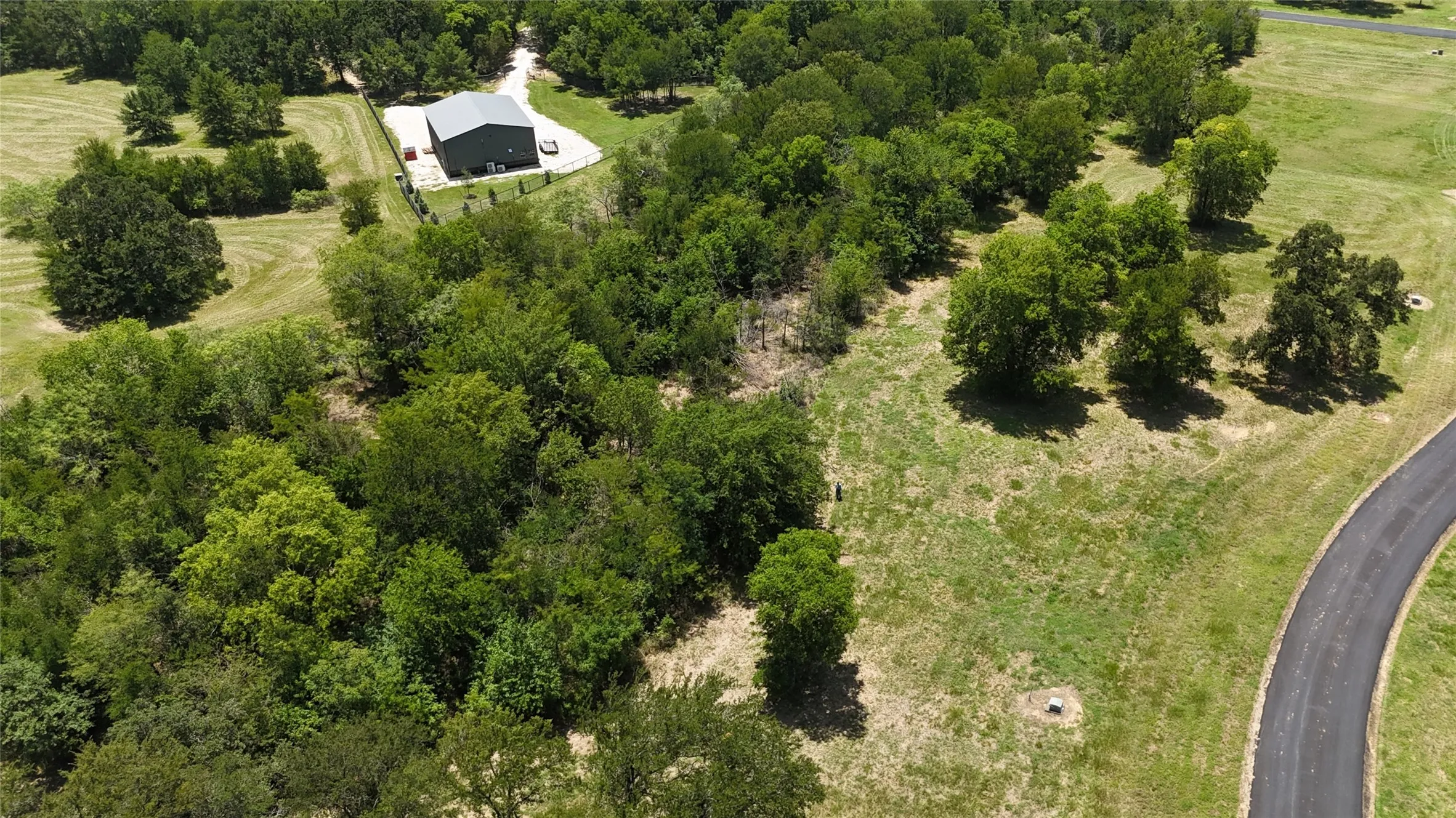 Aerial photo showing the peaceful private paved road frontage along Lot 118 in gated Admiral Shores.