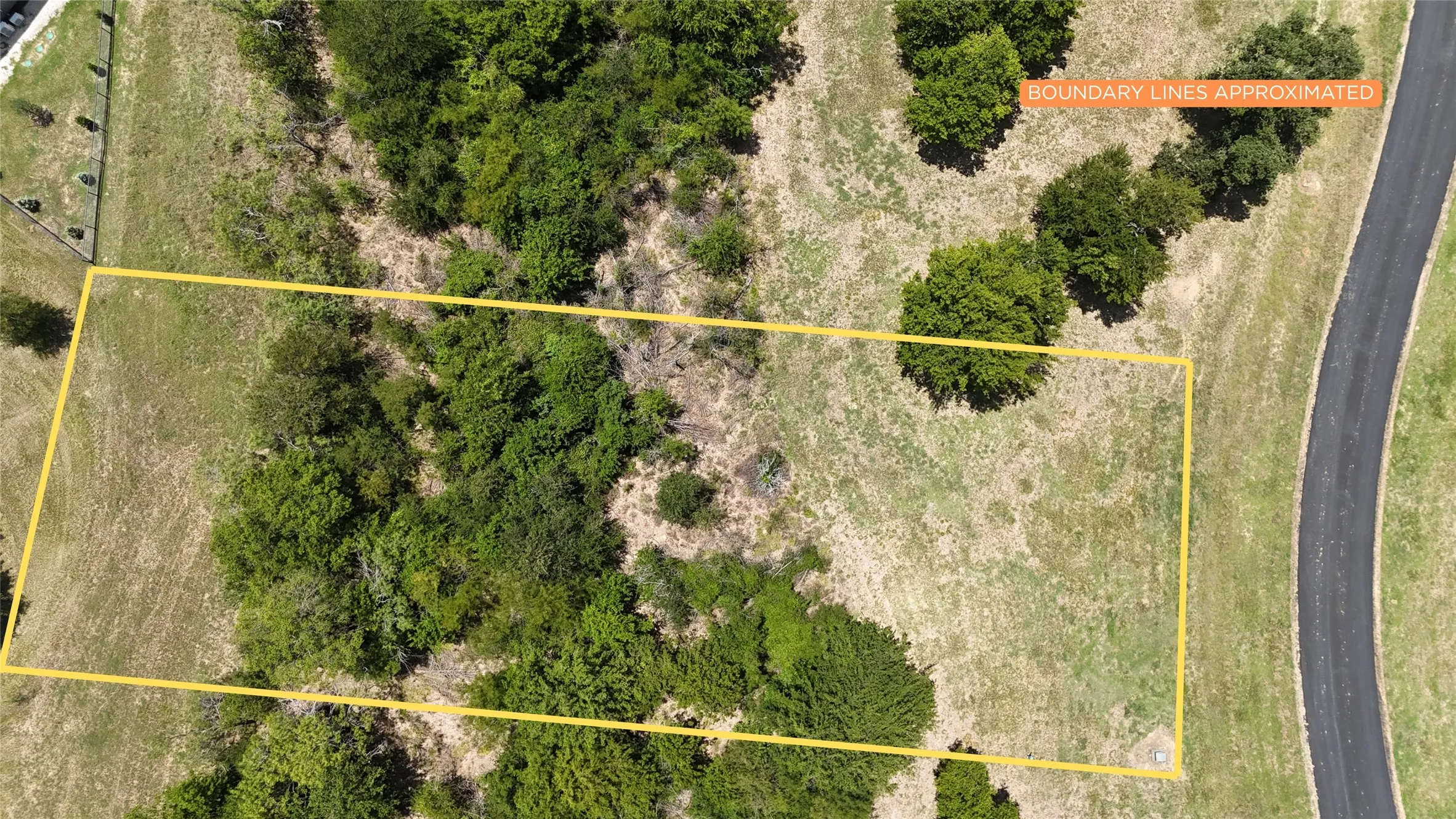 Detailed aerial shot showing natural tree distribution and cleared building footprints.